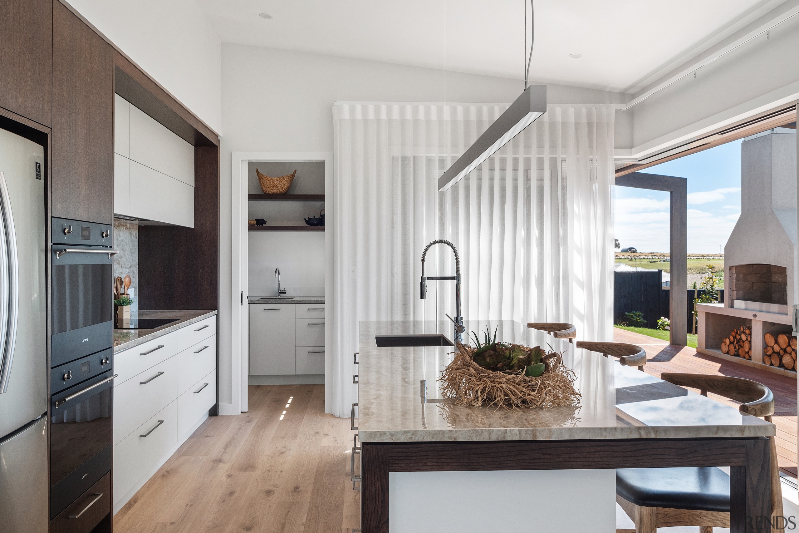 A raked ceiling features over the open-plan kitchen, 