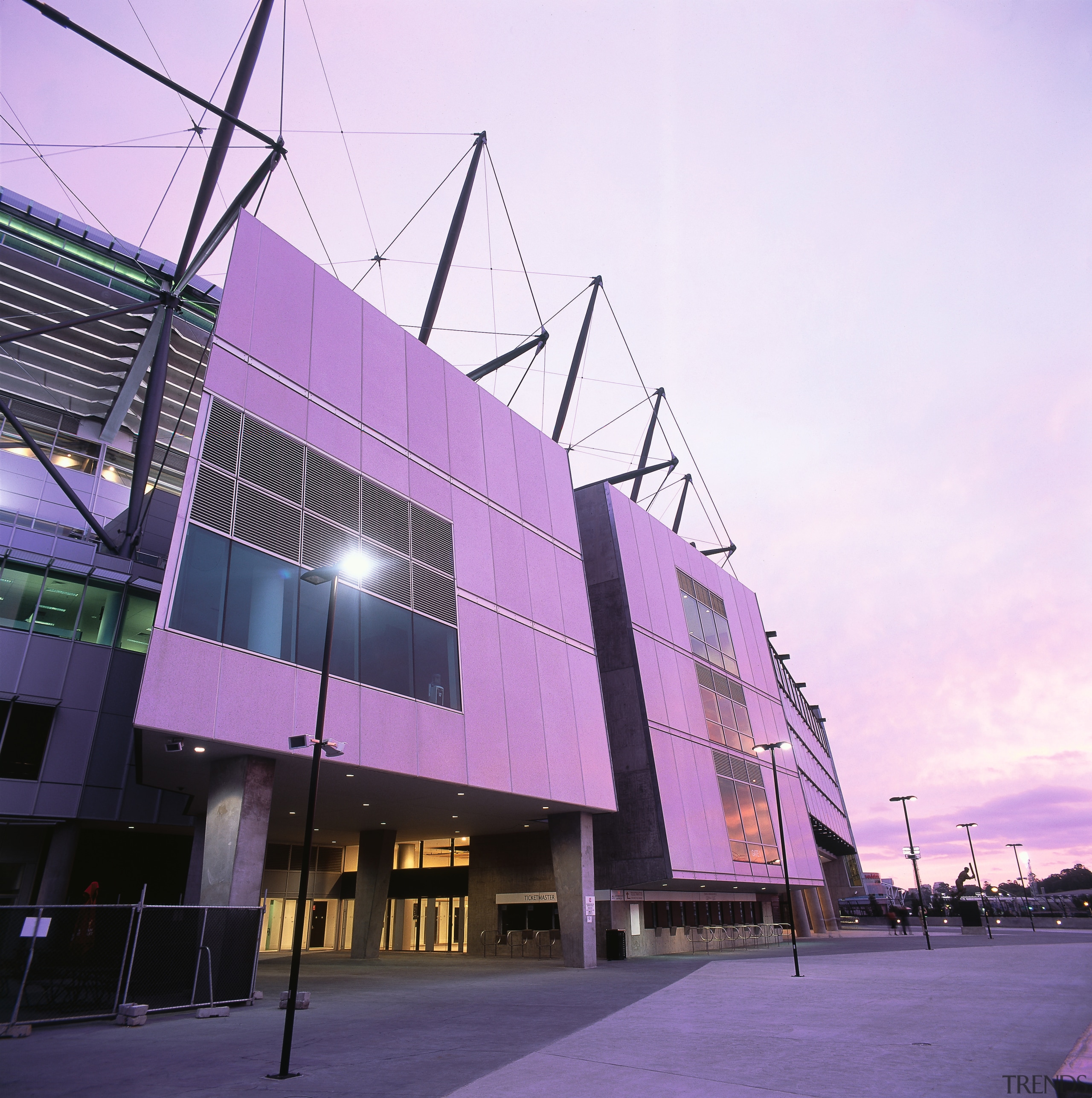 Exterior view of refurbished Melbourne Cricket Ground entrance. architecture, building, commercial building, convention center, corporate headquarters, facade, metropolis, metropolitan area, mixed use, purple, sky, sport venue, structure, tourist attraction, purple