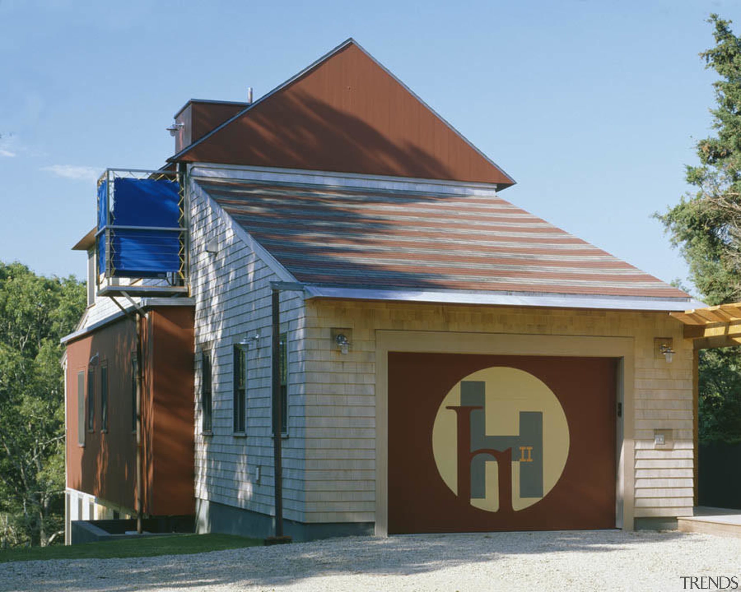 Exterior view of this home which features an building, facade, home, house, real estate, roof, shed, teal