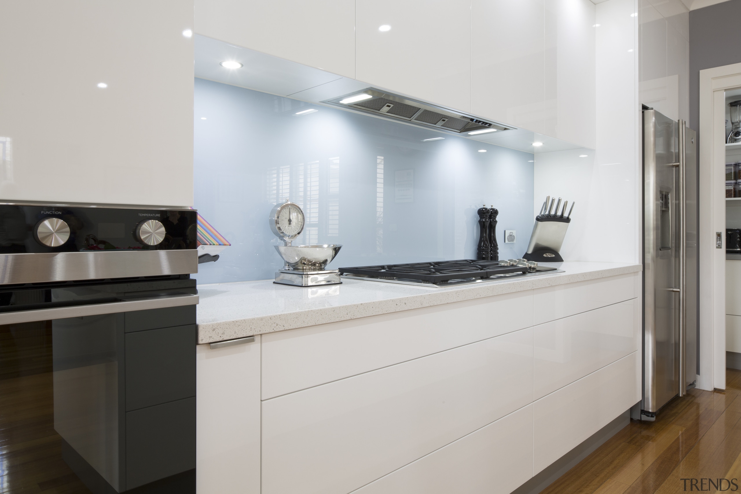 Clean-lined white kitchen by Kitchen &amp; Home with cabinetry, countertop, cuisine classique, interior design, kitchen, room, gray