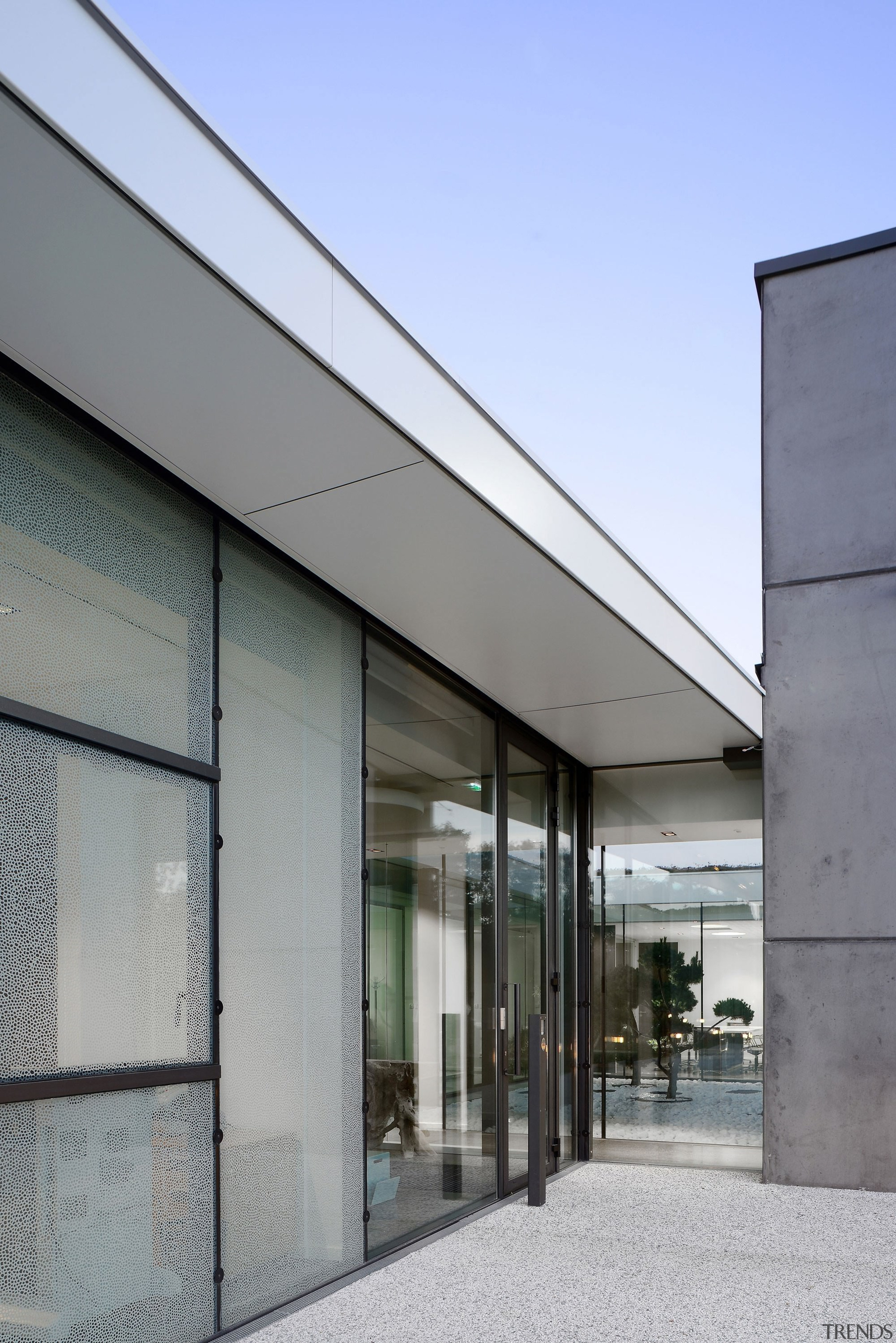 The roof wraps around into a soffit - architecture, building, facade, glass, house, sky, gray