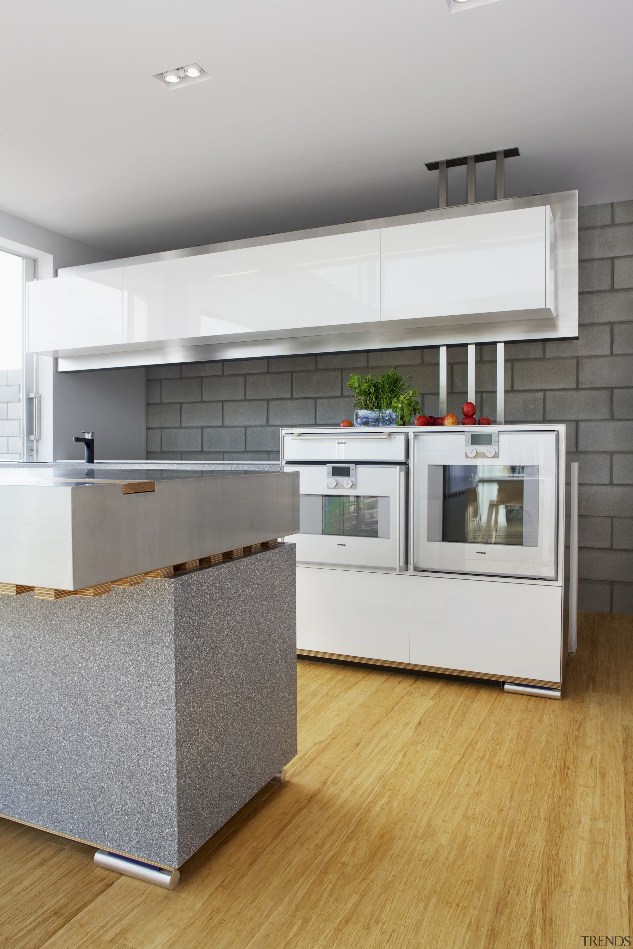 This kitchen features stainless steel benchtops. It was cabinetry, countertop, cuisine classique, floor, hardwood, home appliance, interior design, kitchen, laminate flooring, room, wood flooring, gray