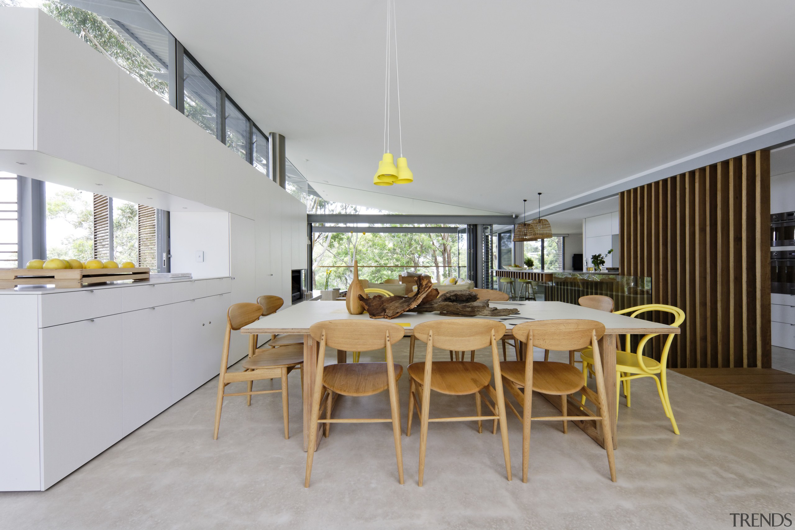 The dining area of this home is at architecture, dining room, house, interior design, real estate, table, gray