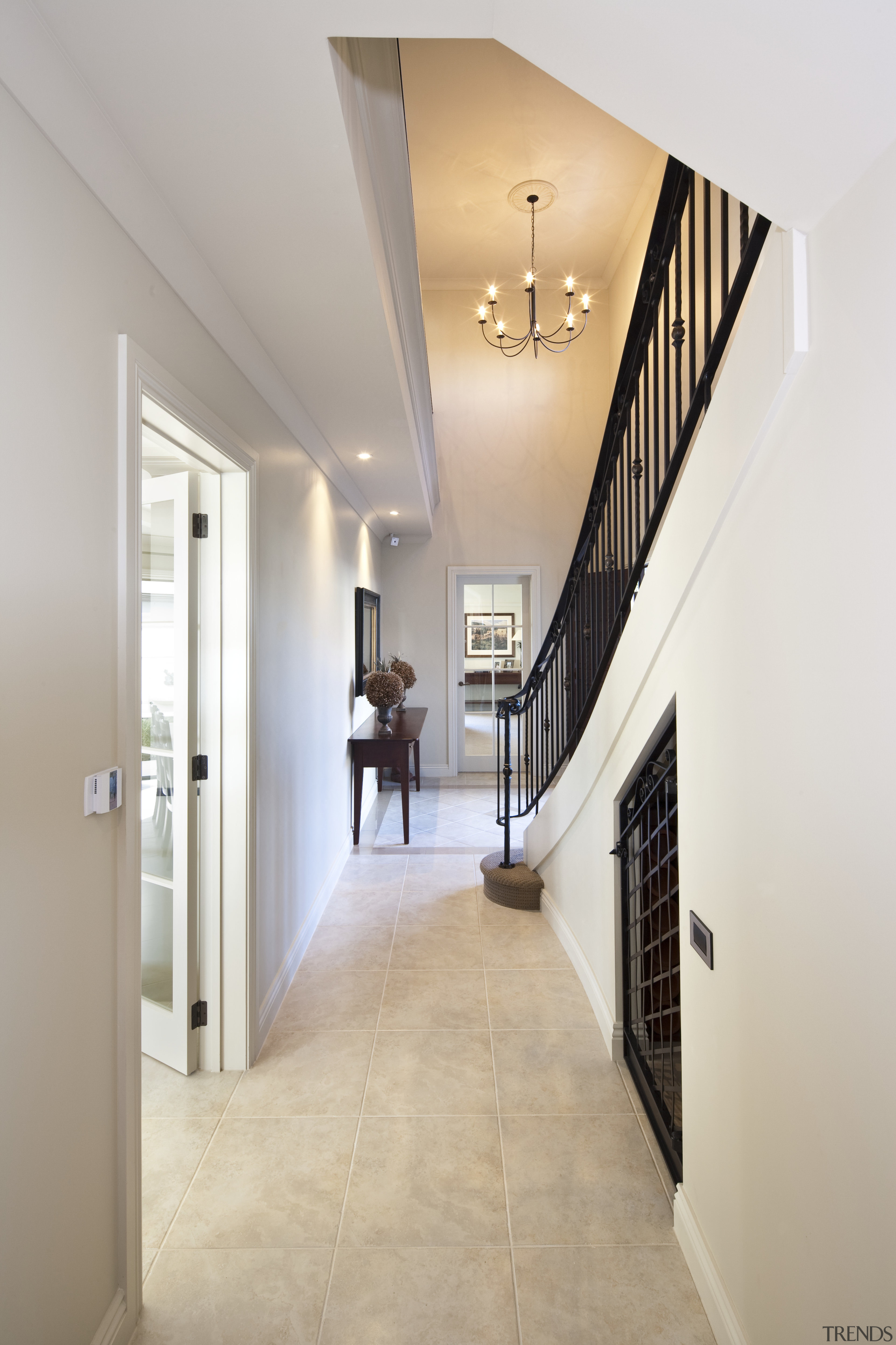 View of a hallway with tiled floors. - apartment, architecture, ceiling, daylighting, estate, floor, flooring, hall, handrail, home, house, interior design, lobby, property, real estate, stairs, wall, wood flooring, gray