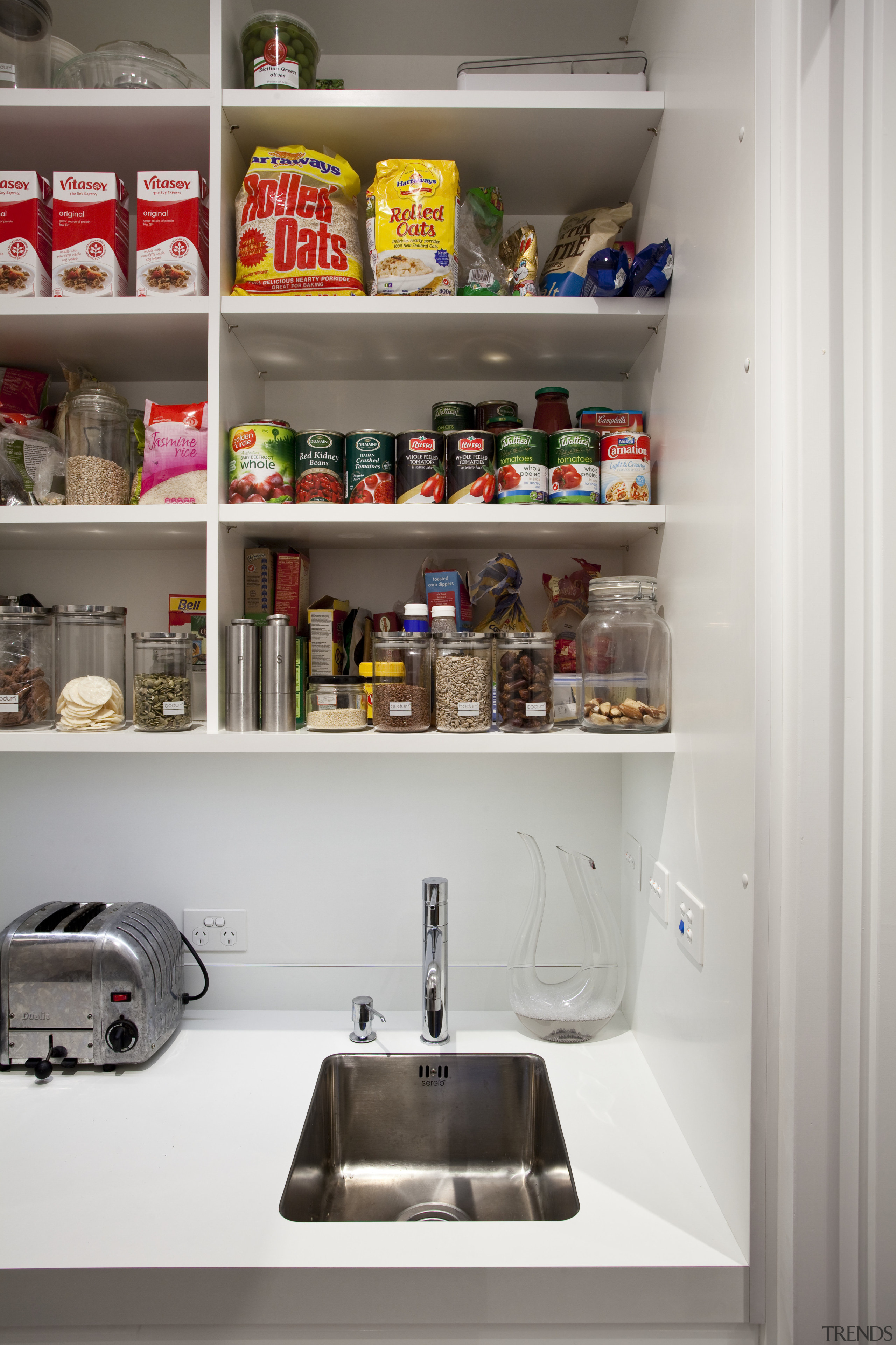 Designed by Morgan Cronin of Cronin Kitchens, this kitchen, kitchen organizer, pantry, product, refrigerator, shelf, shelving, white, gray