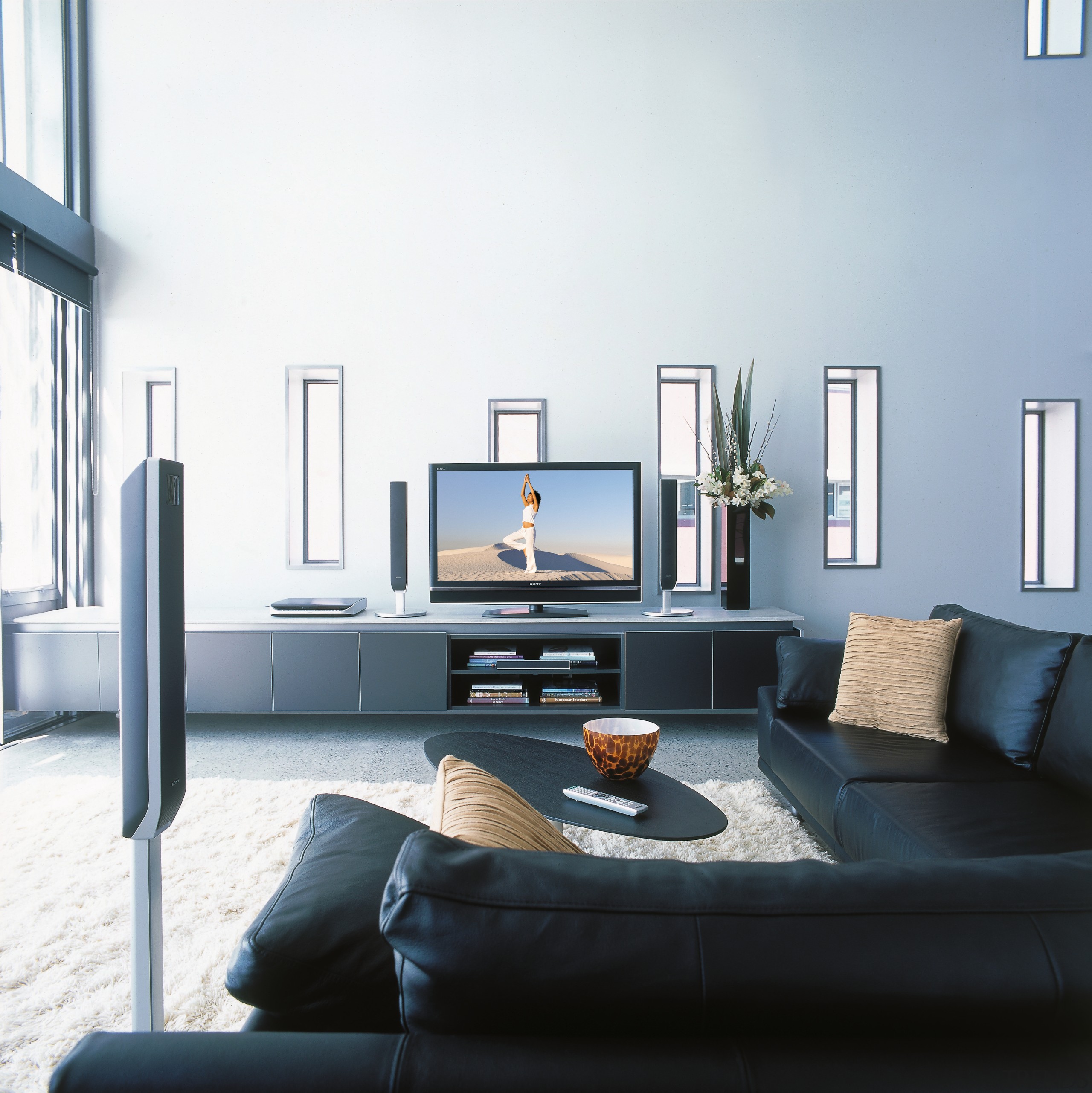 A view of a home entertainment system from furniture, interior design, living room, room, table, white, black