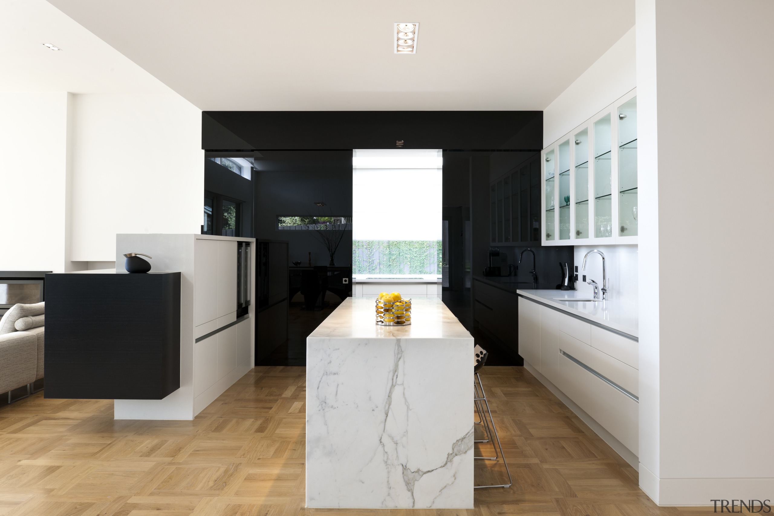 A black glass sliding door opens to a architecture, countertop, floor, flooring, interior design, kitchen, property, real estate, room, white