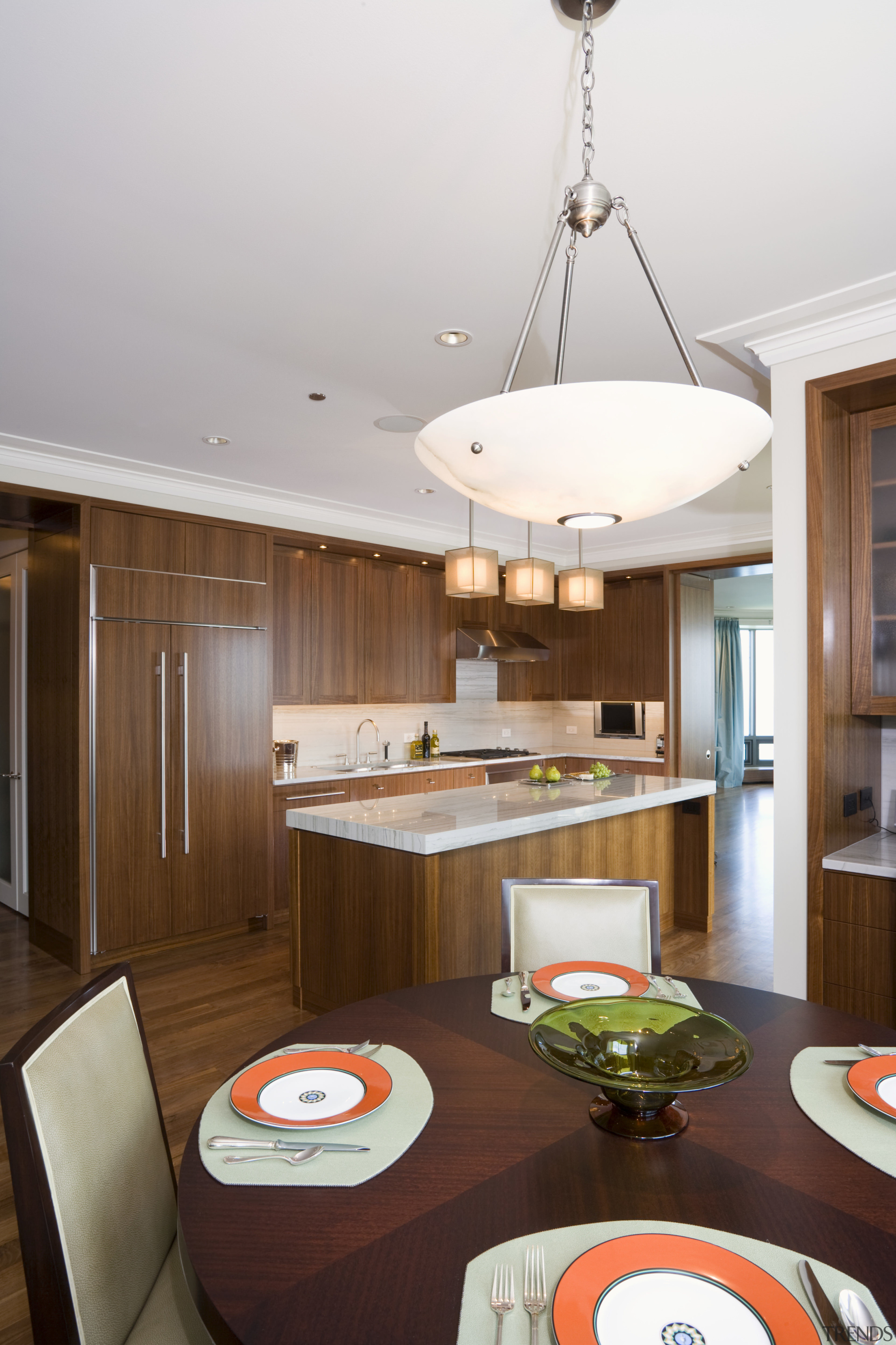 Rich walnut cabinetry features in this apartment kitchen, ceiling, dining room, interior design, kitchen, room, table, white, brown