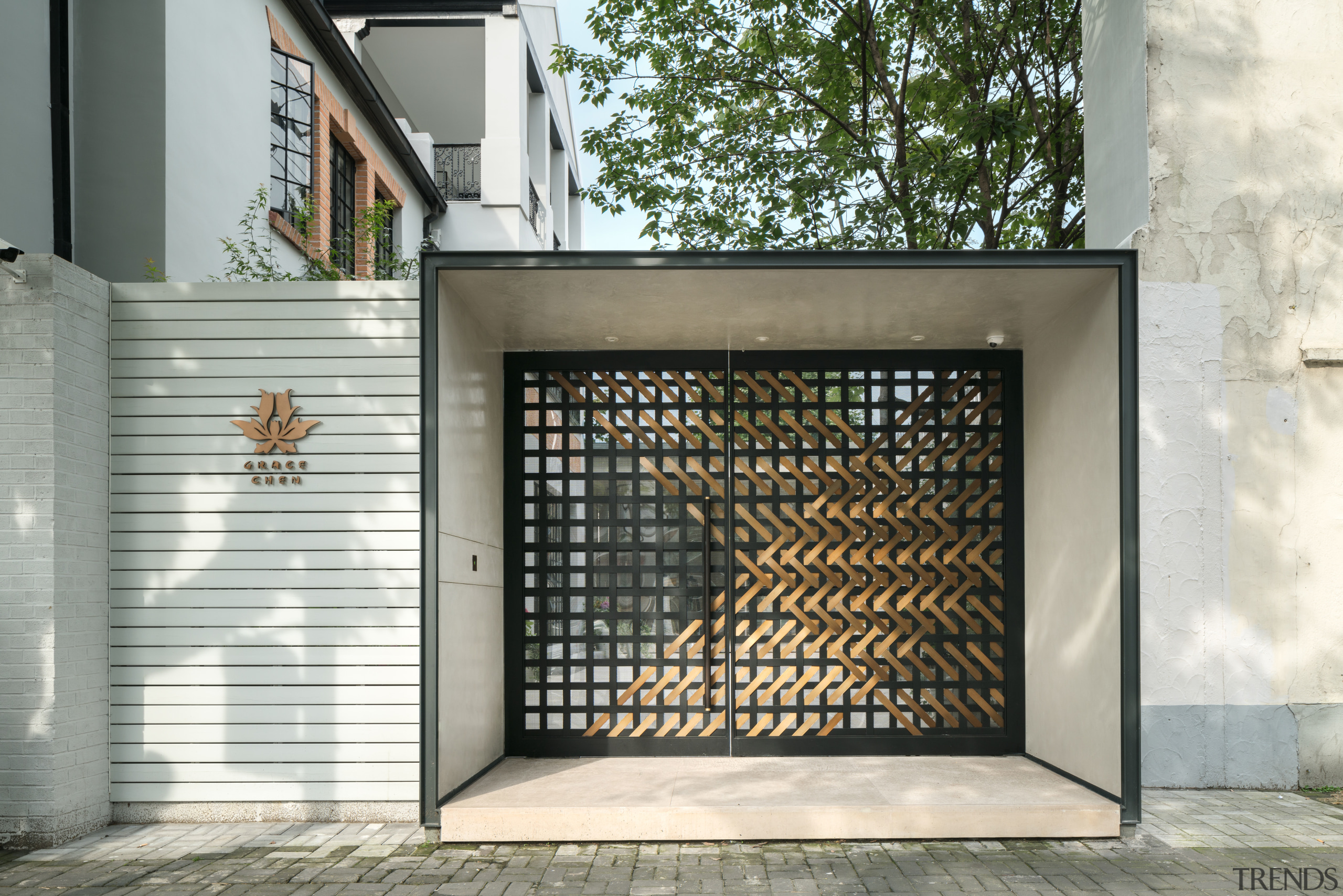 A black-and-bronze woven metal gate, inspired by a door, facade, gate, gray, white
