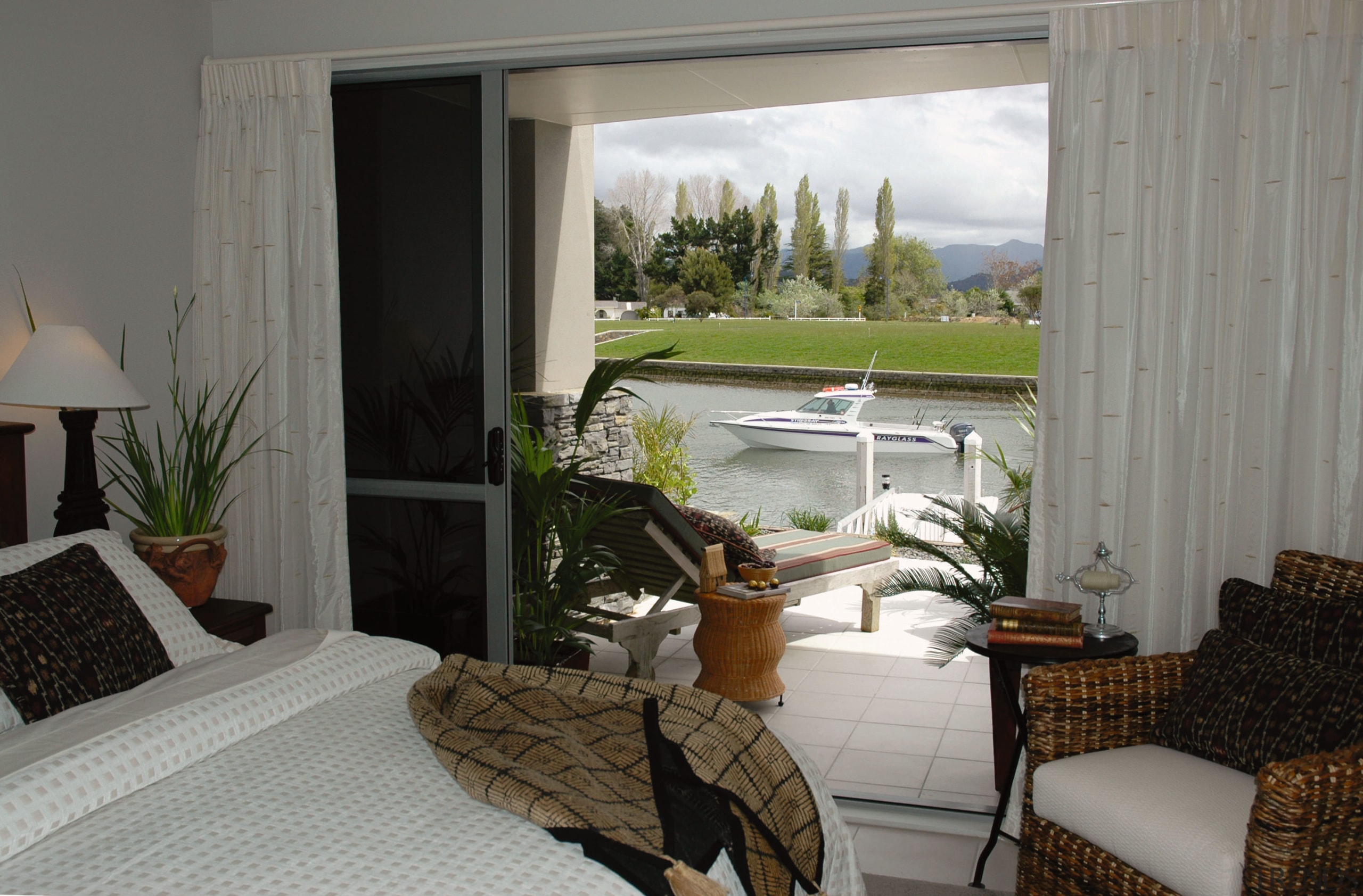 A view of the water ways from a door, home, house, interior design, living room, property, real estate, room, window, window treatment, gray