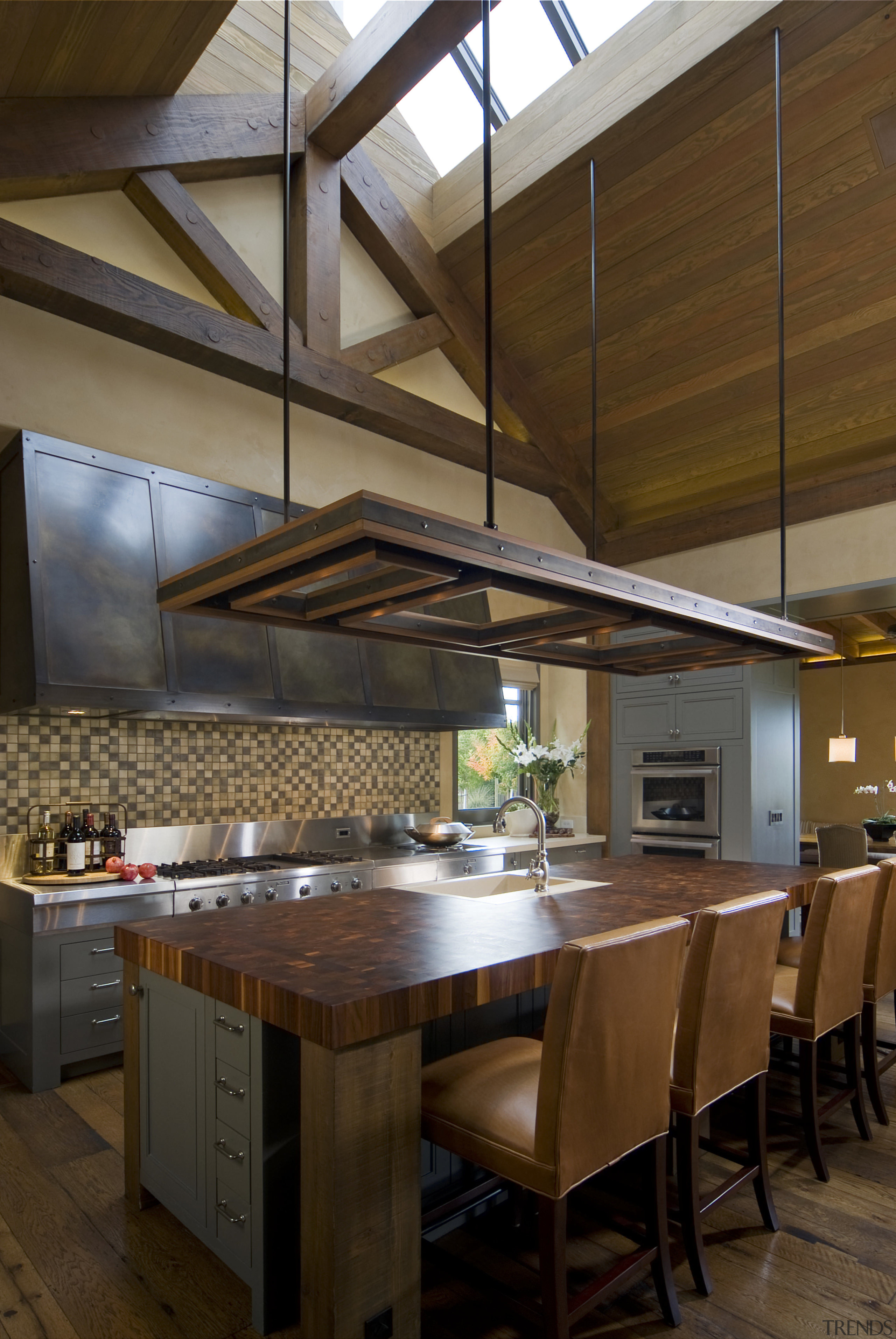 View of kitchen, great room and wine cellar. beam, cabinetry, ceiling, countertop, cuisine classique, daylighting, interior design, kitchen, table, wood, brown