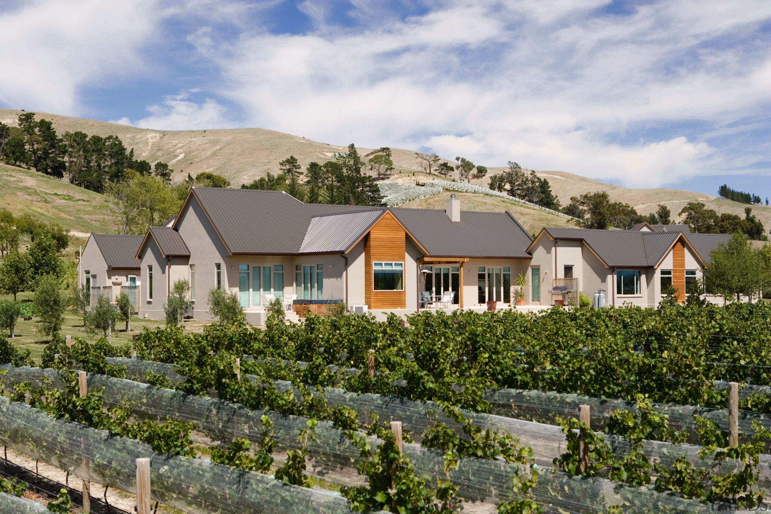 A view of a home constructed by Tomlinson cottage, estate, farmhouse, home, house, mountain, property, real estate, residential area, roof, rural area, sky, suburb, tree, village, gray, brown