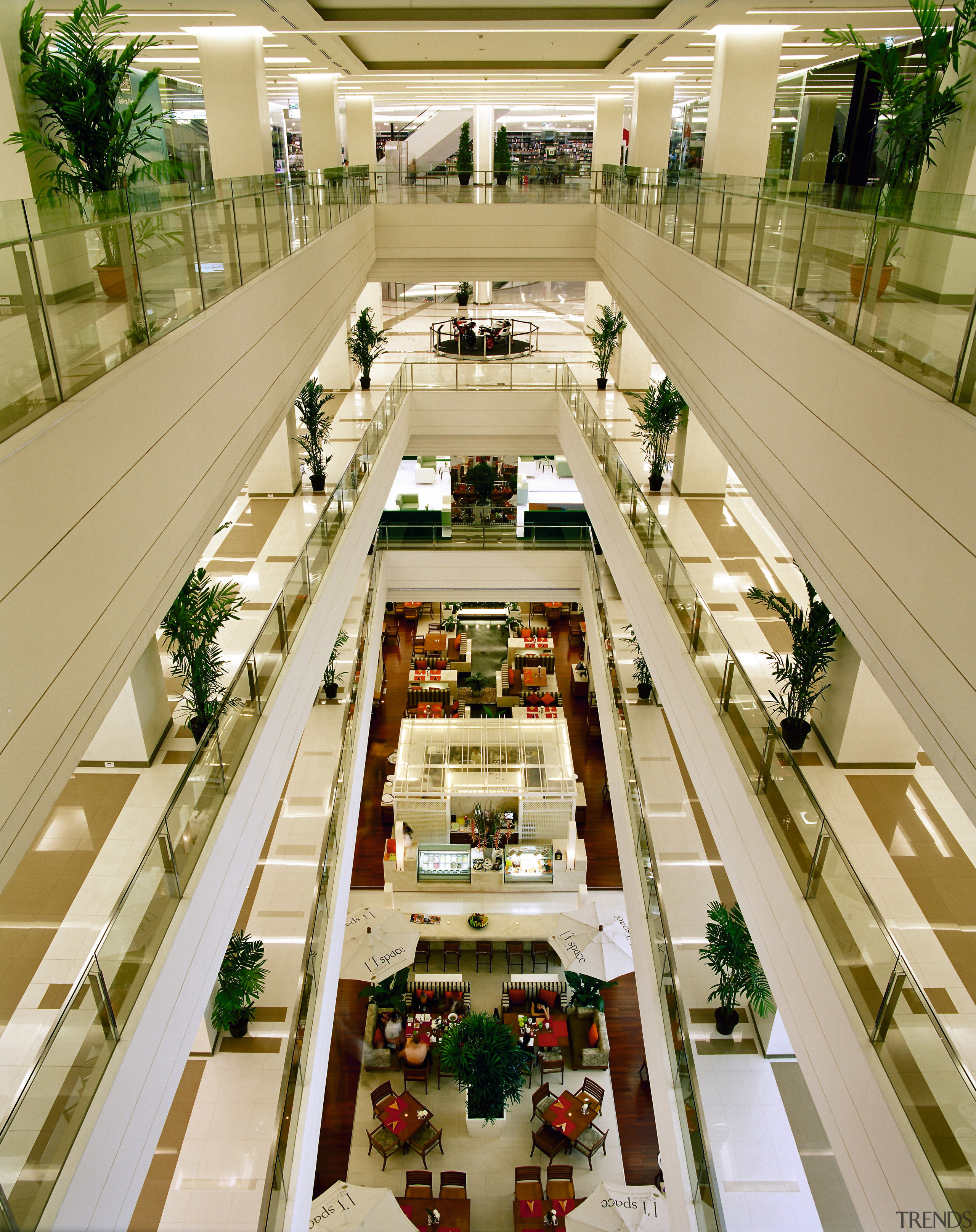 An interior view of the entire shopping complex. metropolitan area, mixed use, shopping mall, orange, brown