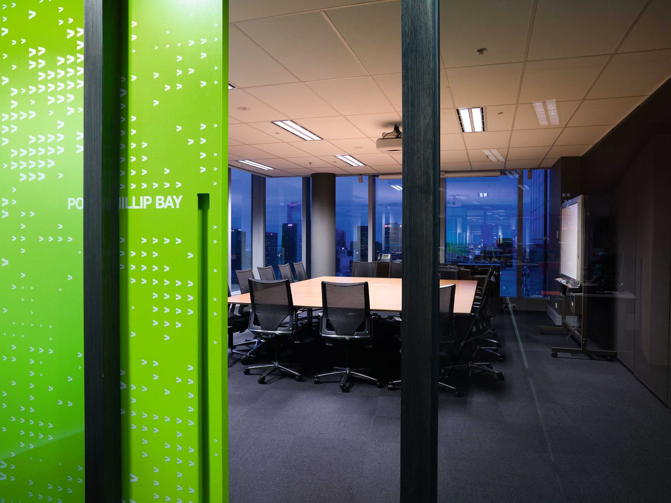 A view of the meeting room featuring table, architecture, ceiling, glass, interior design, lighting, office, black, green