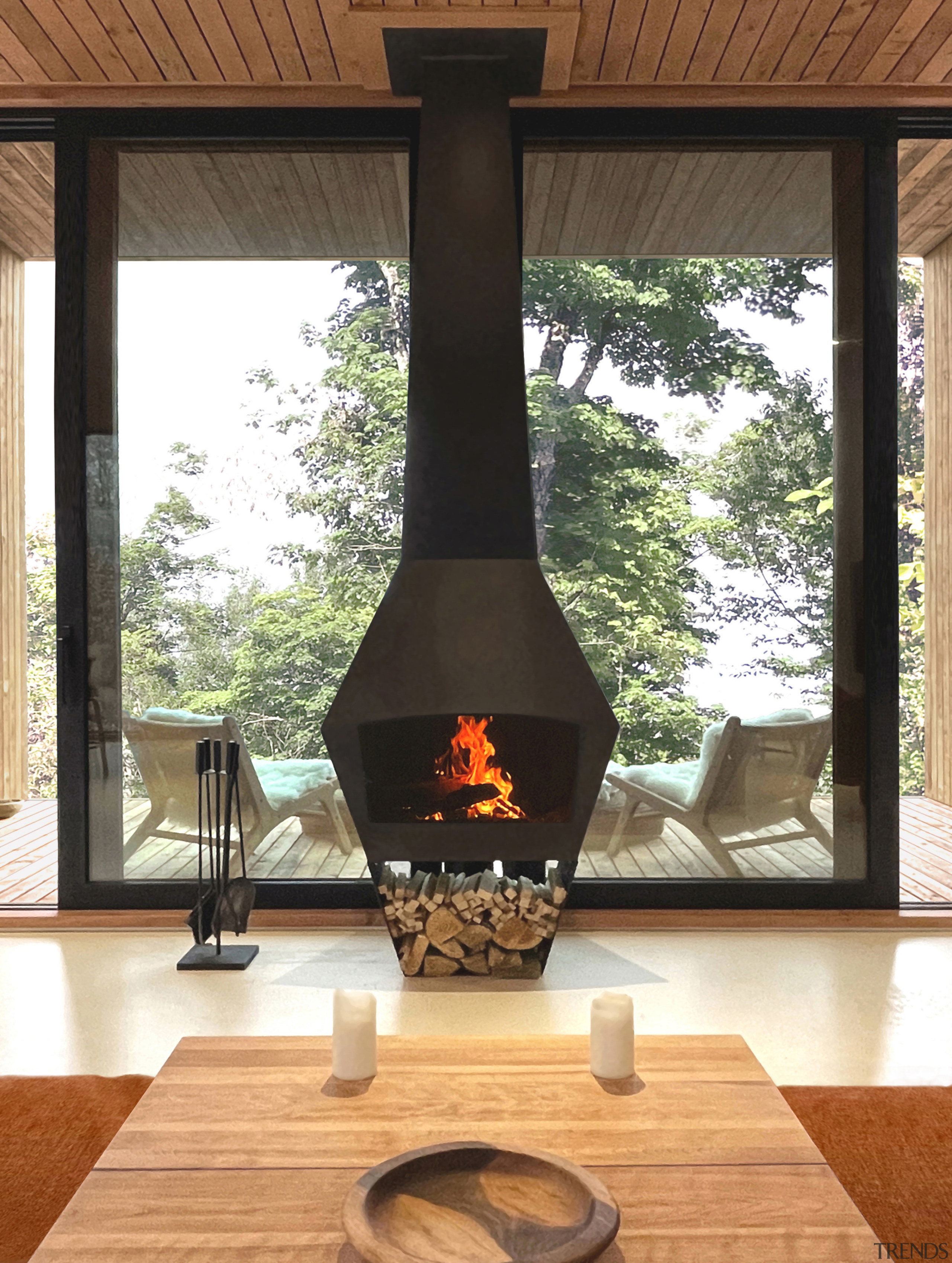 The sculptural wood-burning fireplace maximises comfort while minimising 