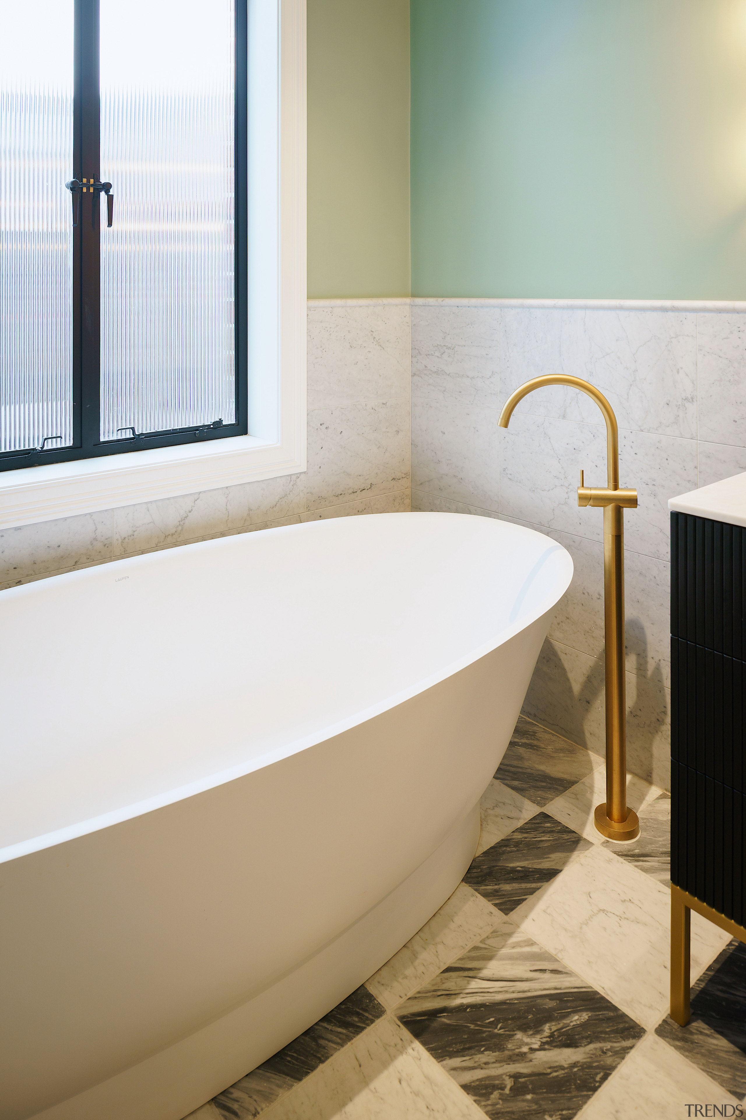 A sculptural tub with floor-mounted filler add to 