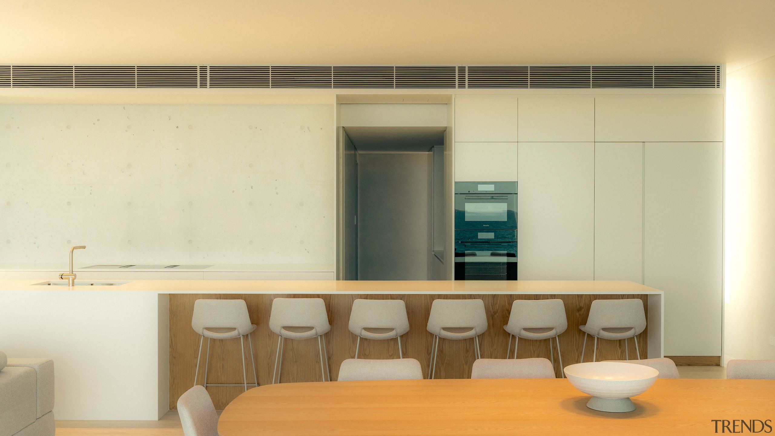 The handless kitchen cabinetry all but disappears into 