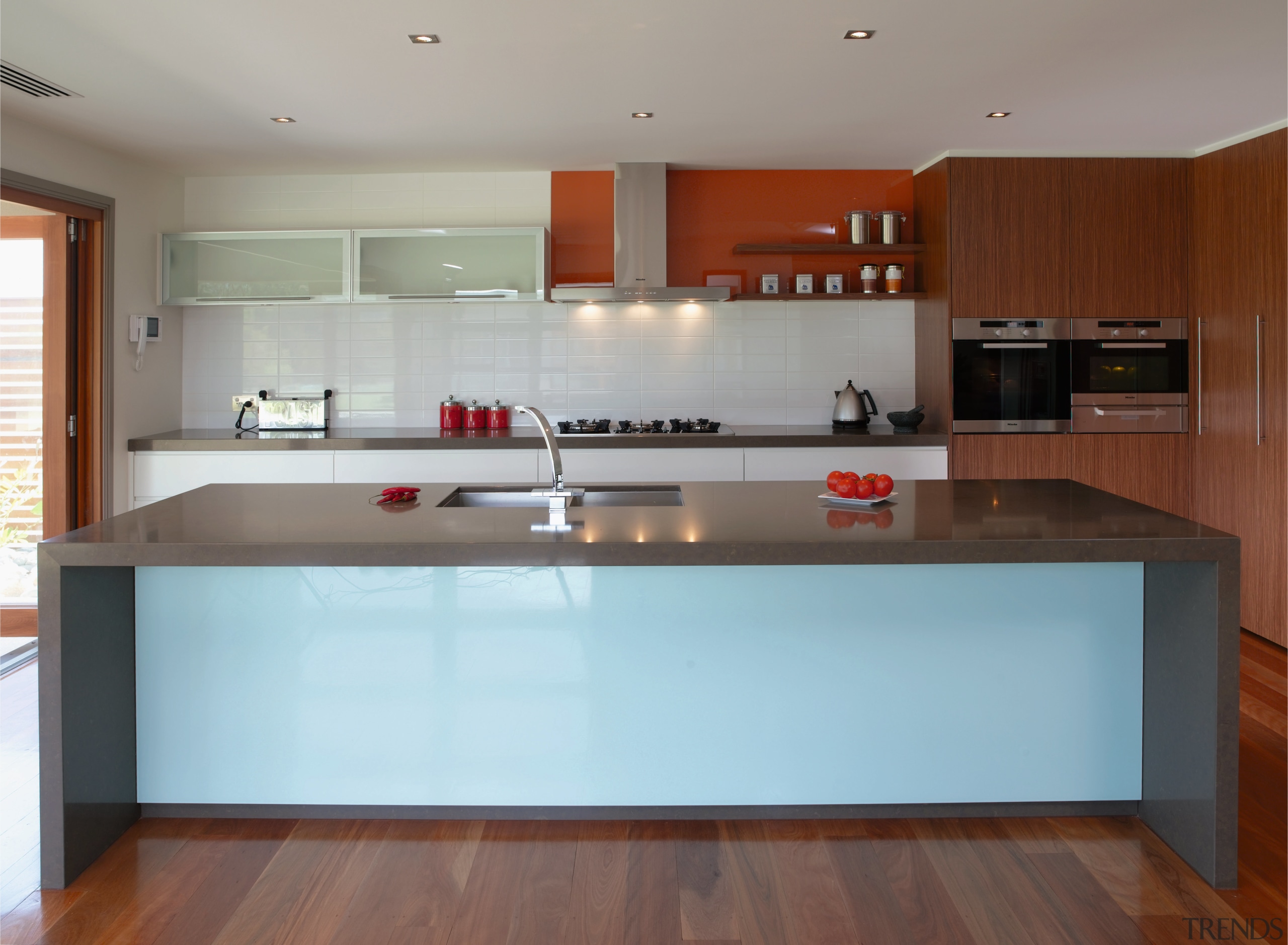 View of this kitchen featuring timber laminate flooring, cabinetry, countertop, cuisine classique, floor, flooring, hardwood, interior design, kitchen, real estate, room, wood, wood flooring, gray, brown