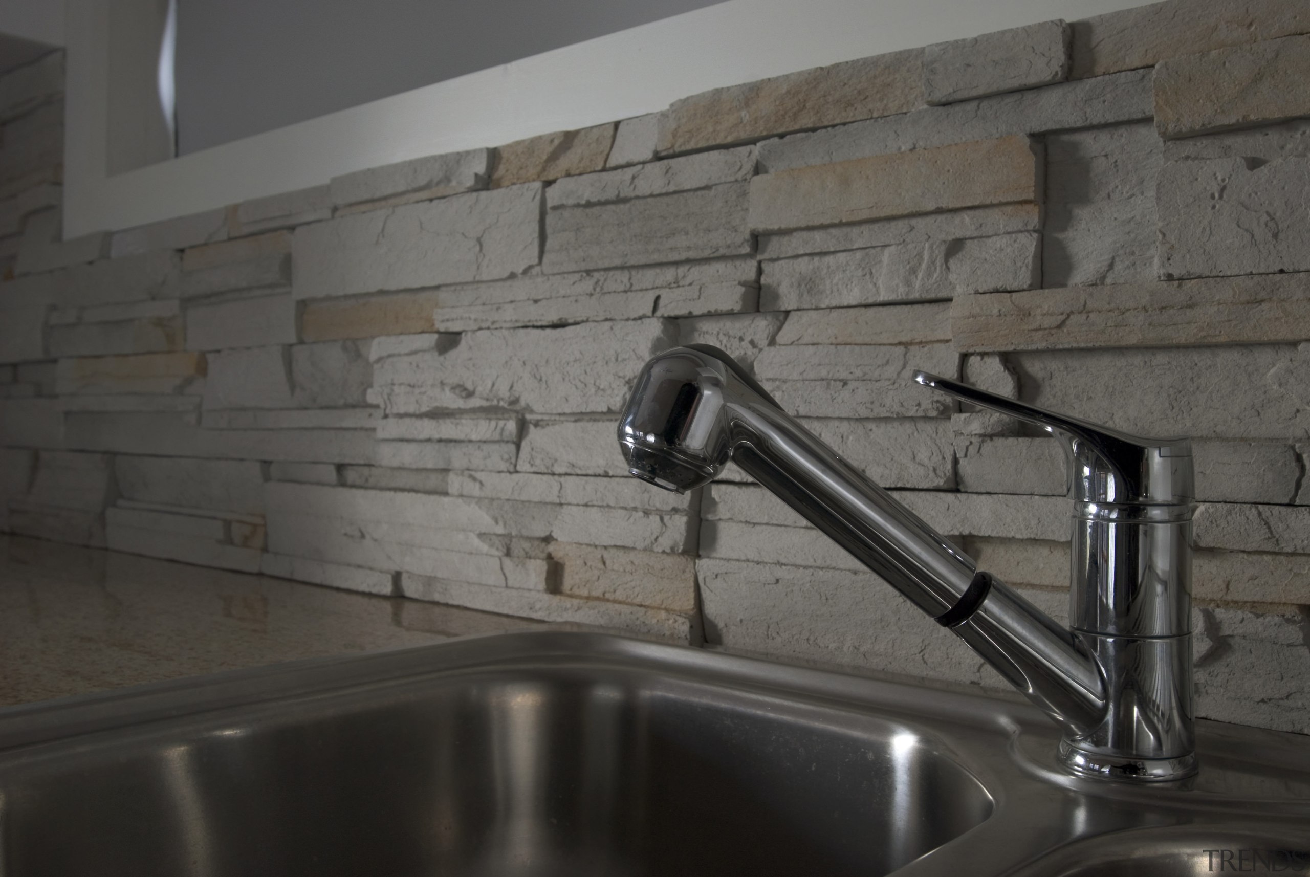 CraftStone has water-retardant elements built in at the countertop, flooring, sink, tap, tile, black, gray