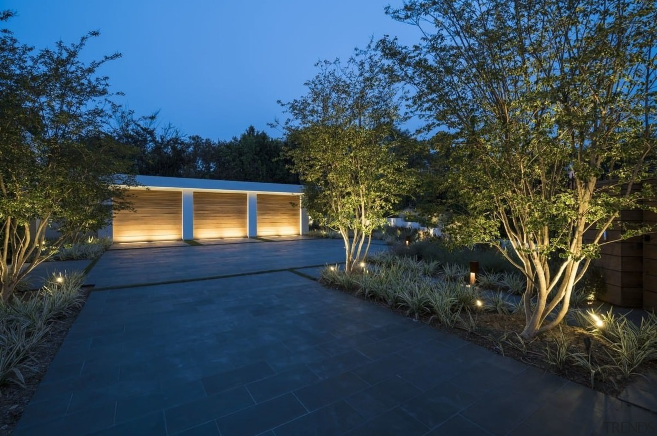 Sited on top of a hill, this home architecture, backyard, cottage, estate, facade, home, house, landscape, landscape lighting, lighting, plant, property, real estate, residential area, shed, siding, sky, tree, yard, blue