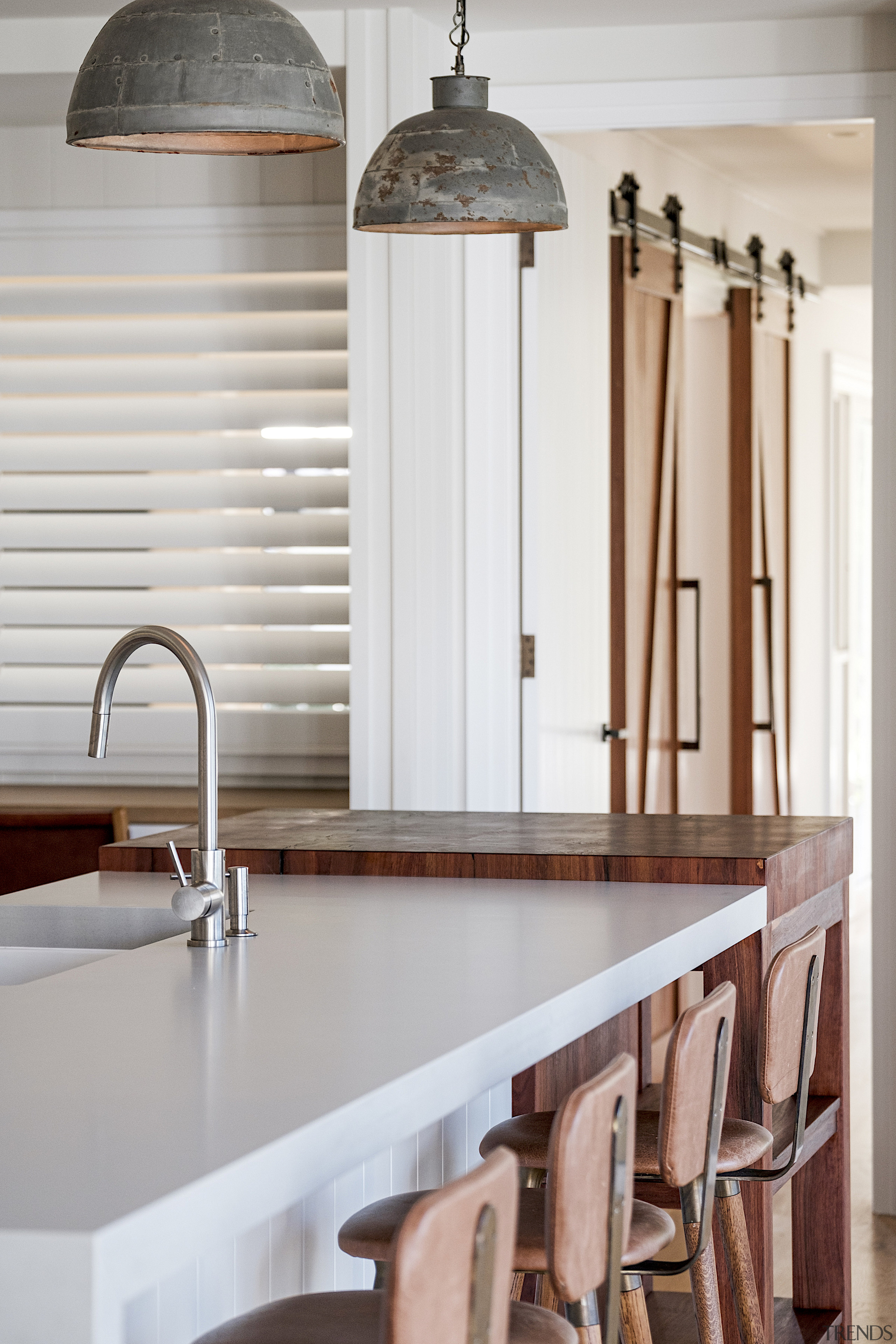 The natural stone-look benchtops in this kitchen are 