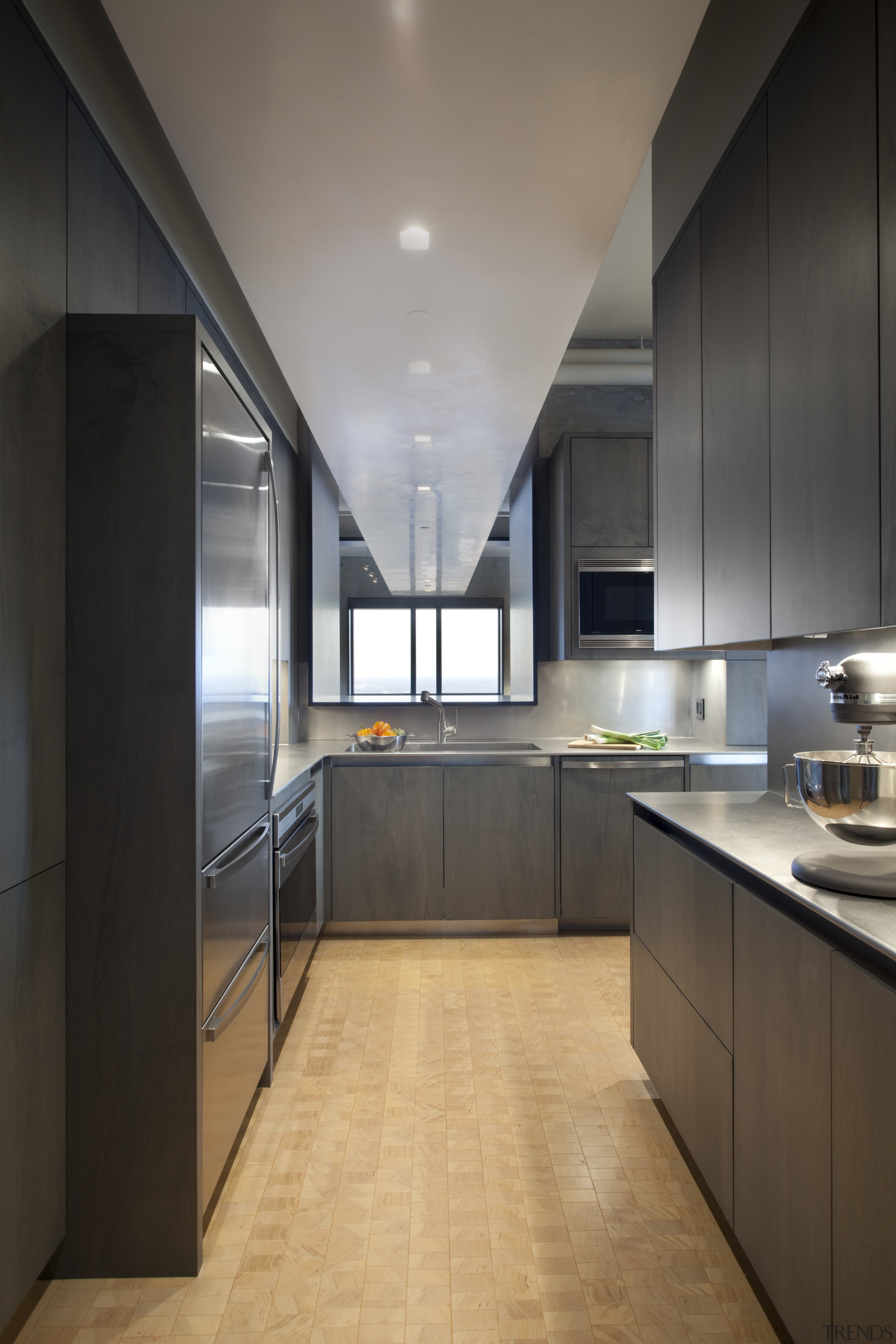 View of an apartment kitchen with dark-toned cabinetry, architecture, cabinetry, ceiling, countertop, cuisine classique, floor, interior design, kitchen, black, gray
