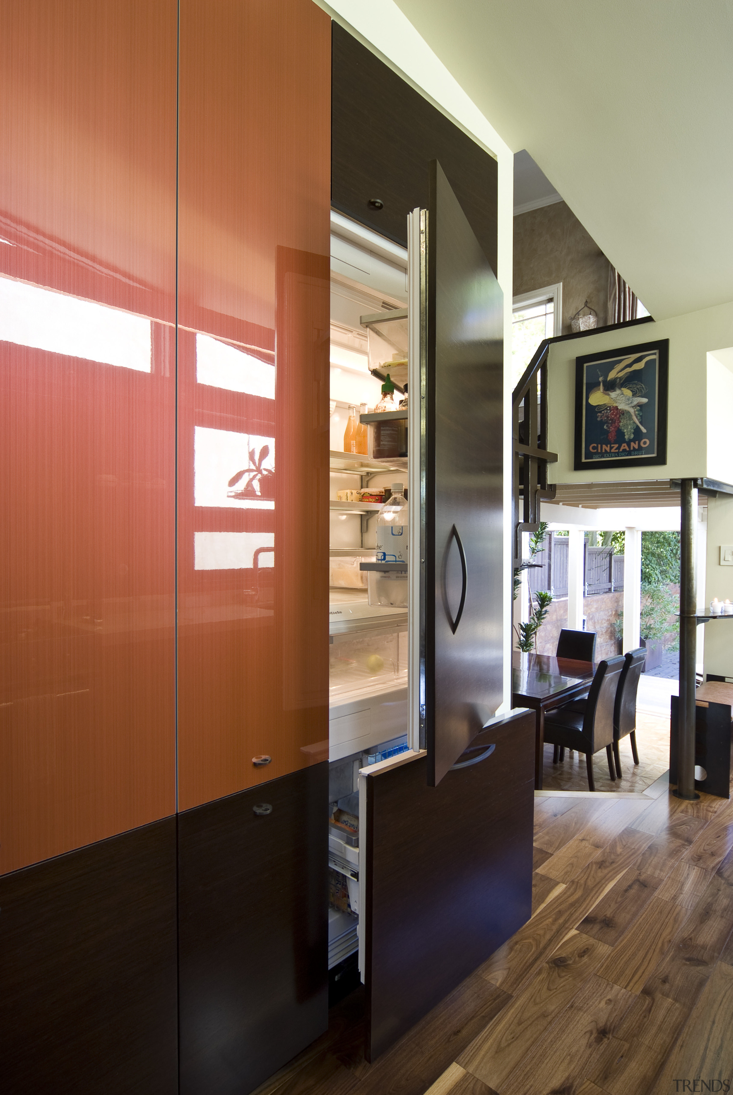 View of kitchen which features custom refrigerator cabinetry. ceiling, furniture, interior design, brown