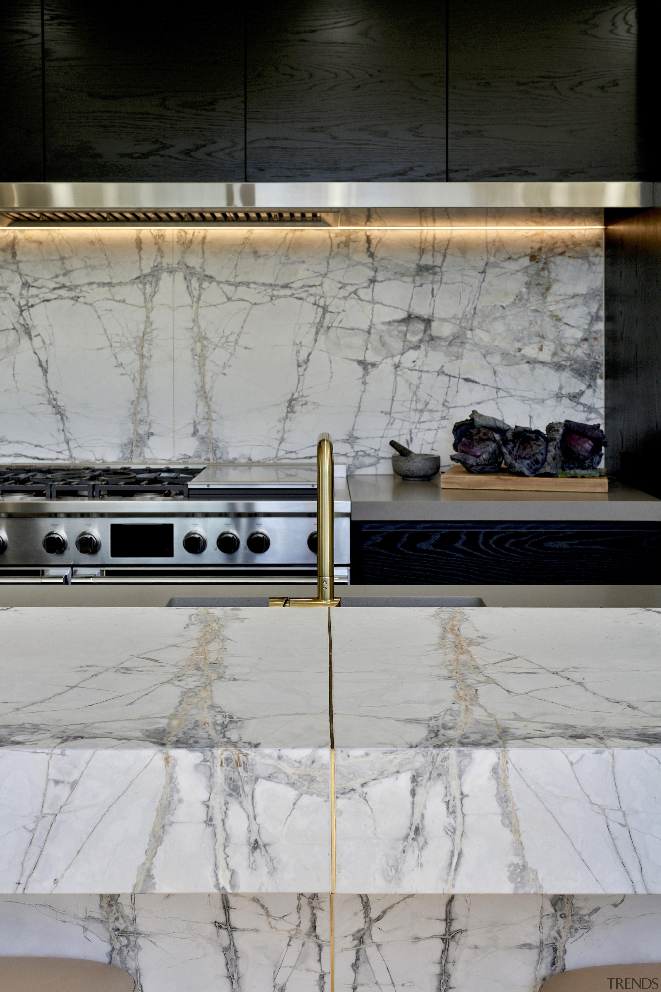 The marble benchtop's brass inlay close up. 