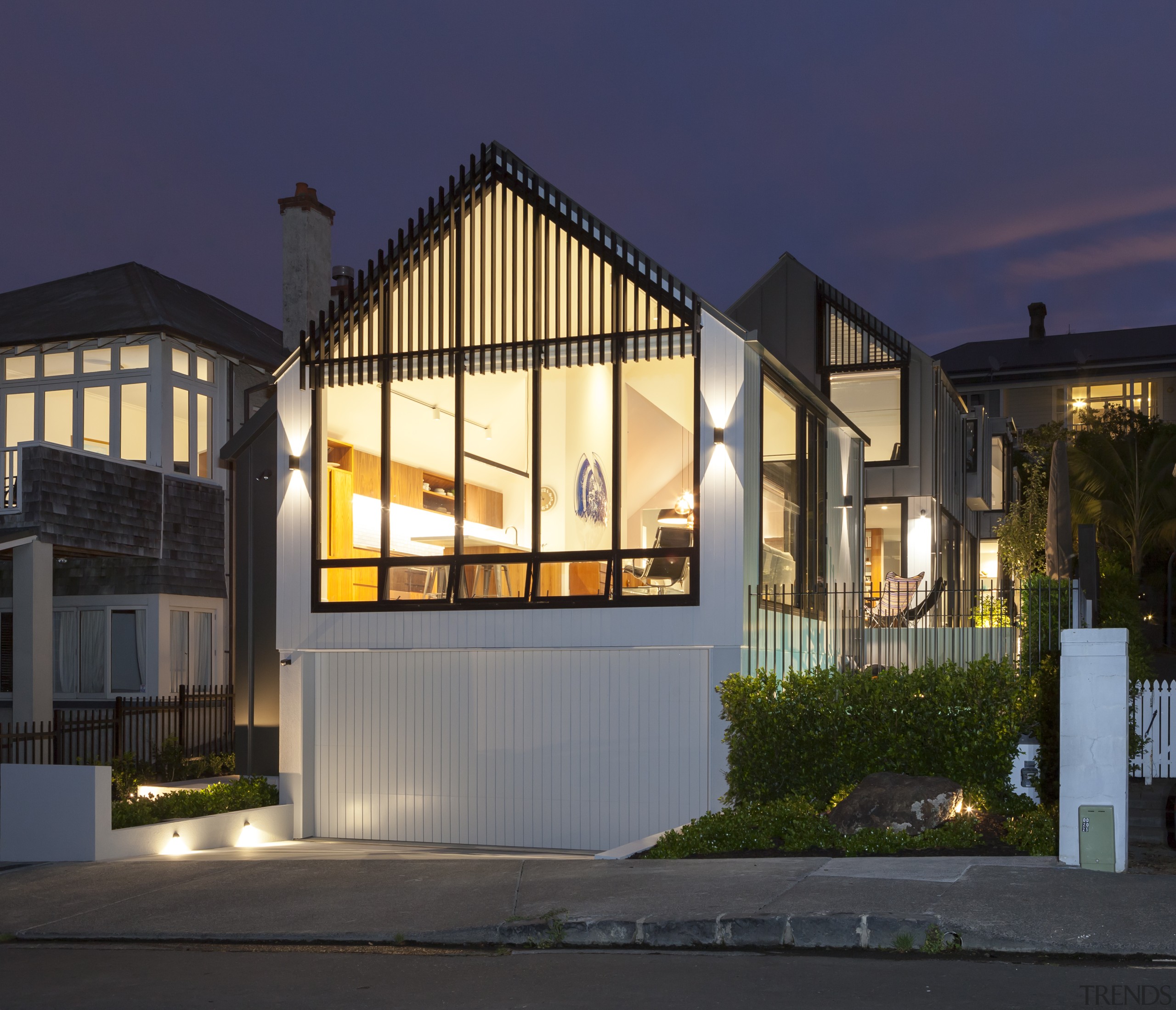 The glazed gable form of the street frontage architecture, building, estate, facade, home, house, interior design, lighting, night, property, real estate, residential area, sky, tree, window, black, blue