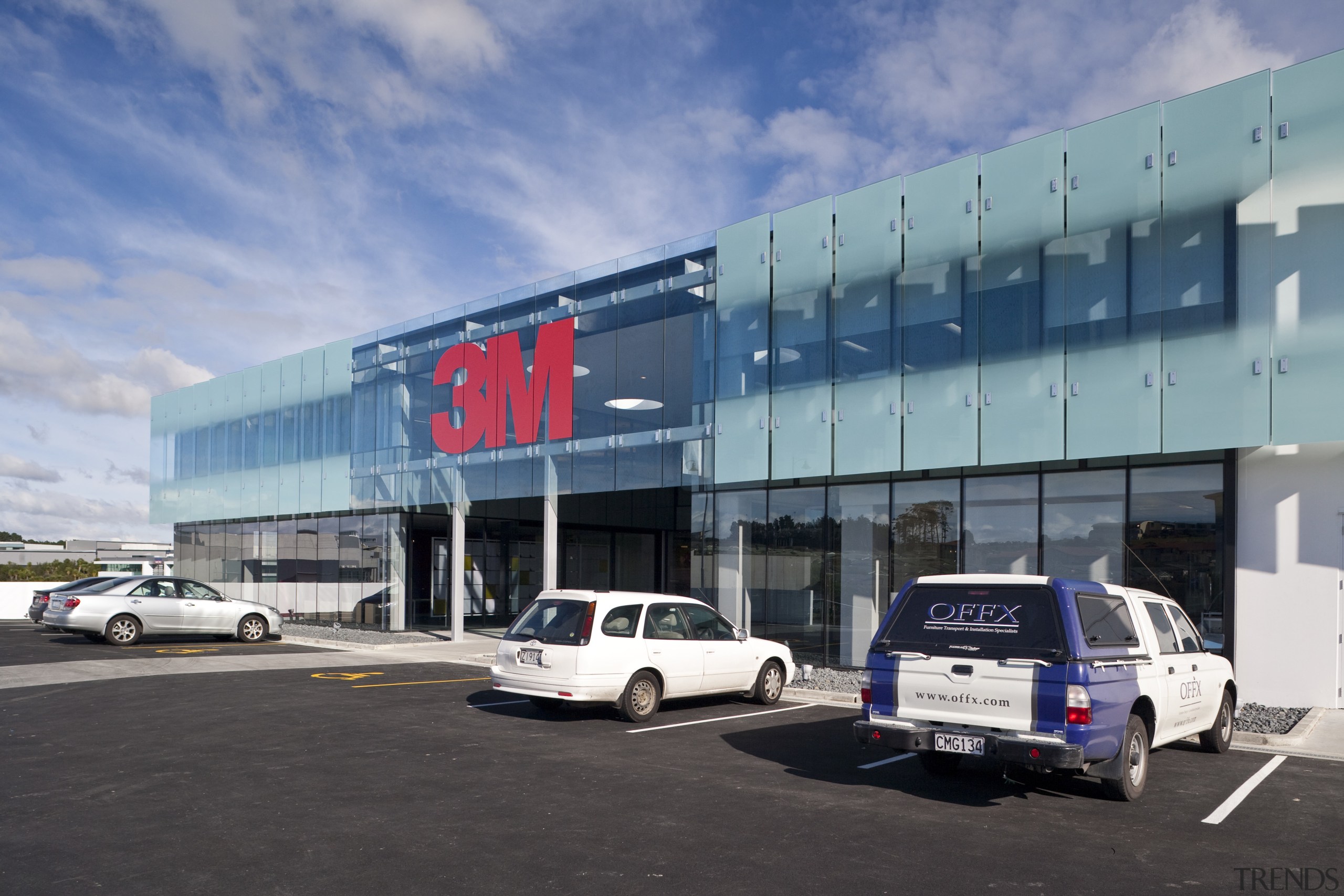 external view of 3M Head Office part of airport terminal, building, car, car dealership, commercial building, corporate headquarters, family car, infrastructure, luxury vehicle, metropolitan area, motor vehicle, sky, structure, transport, teal, black