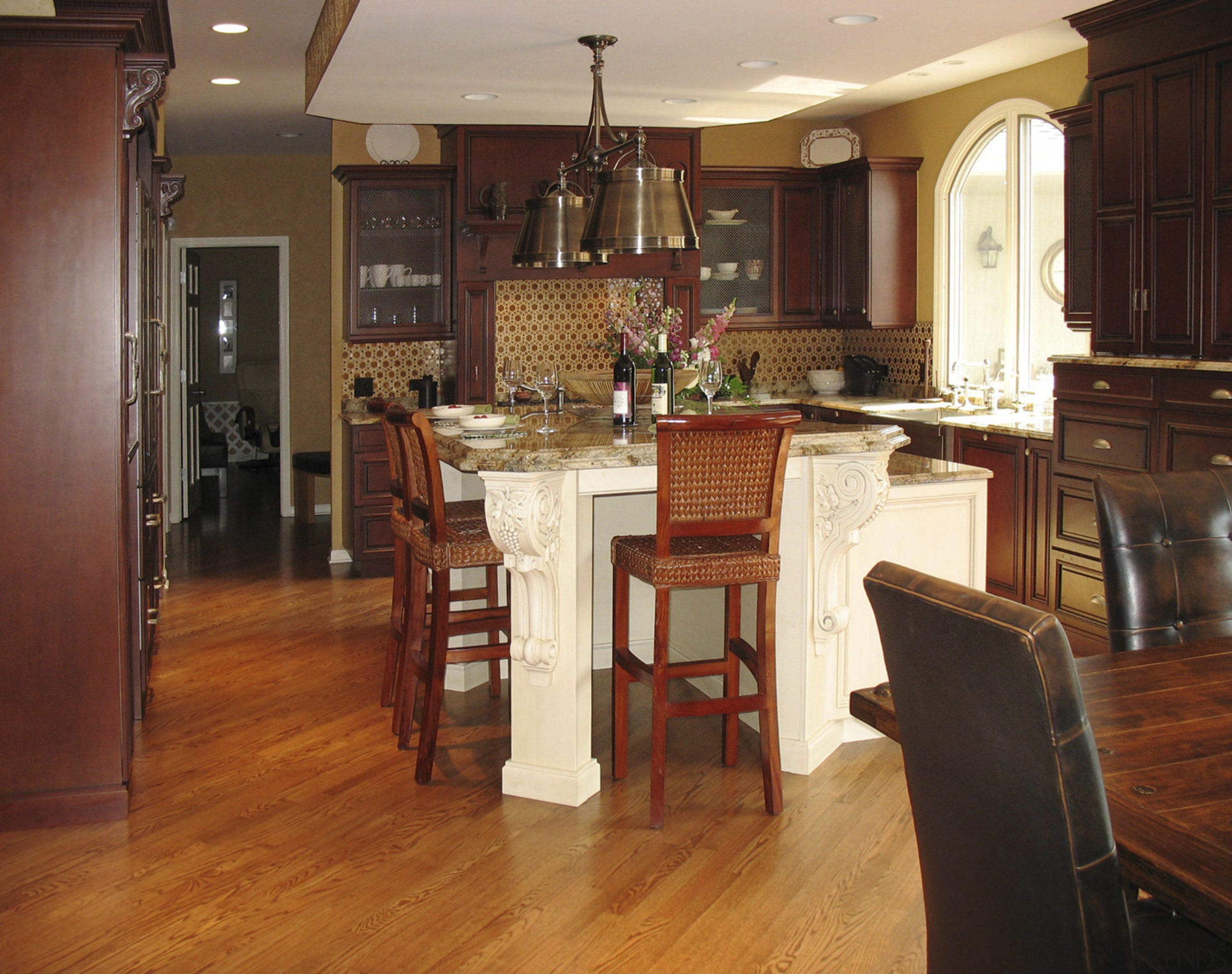 A more traditional look was specified for this cabinetry, countertop, cuisine classique, dining room, floor, flooring, furniture, hardwood, home, interior design, kitchen, laminate flooring, room, table, wood, wood flooring, wood stain, brown, red