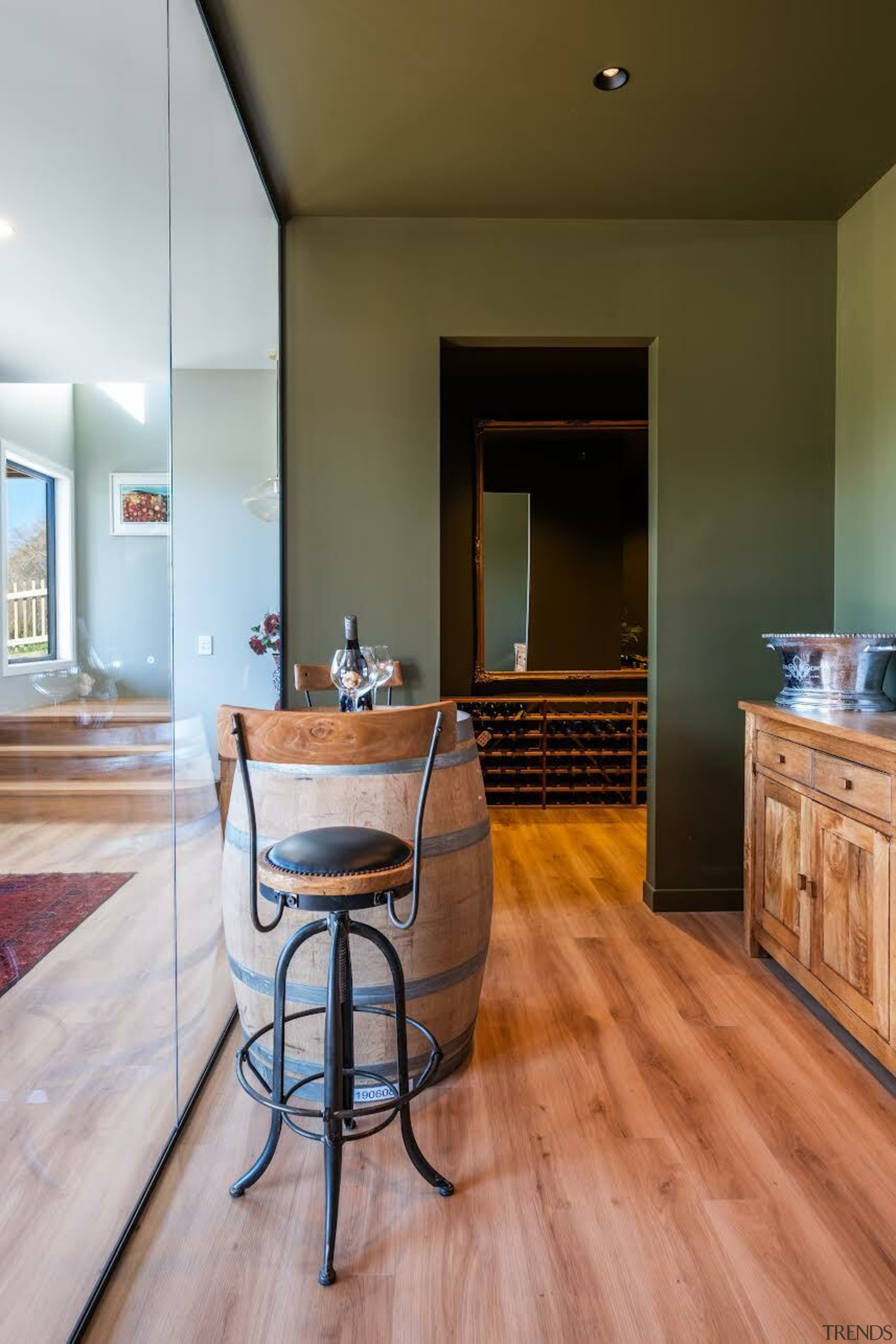 Wine tasting room with glass wall and olive-toned 