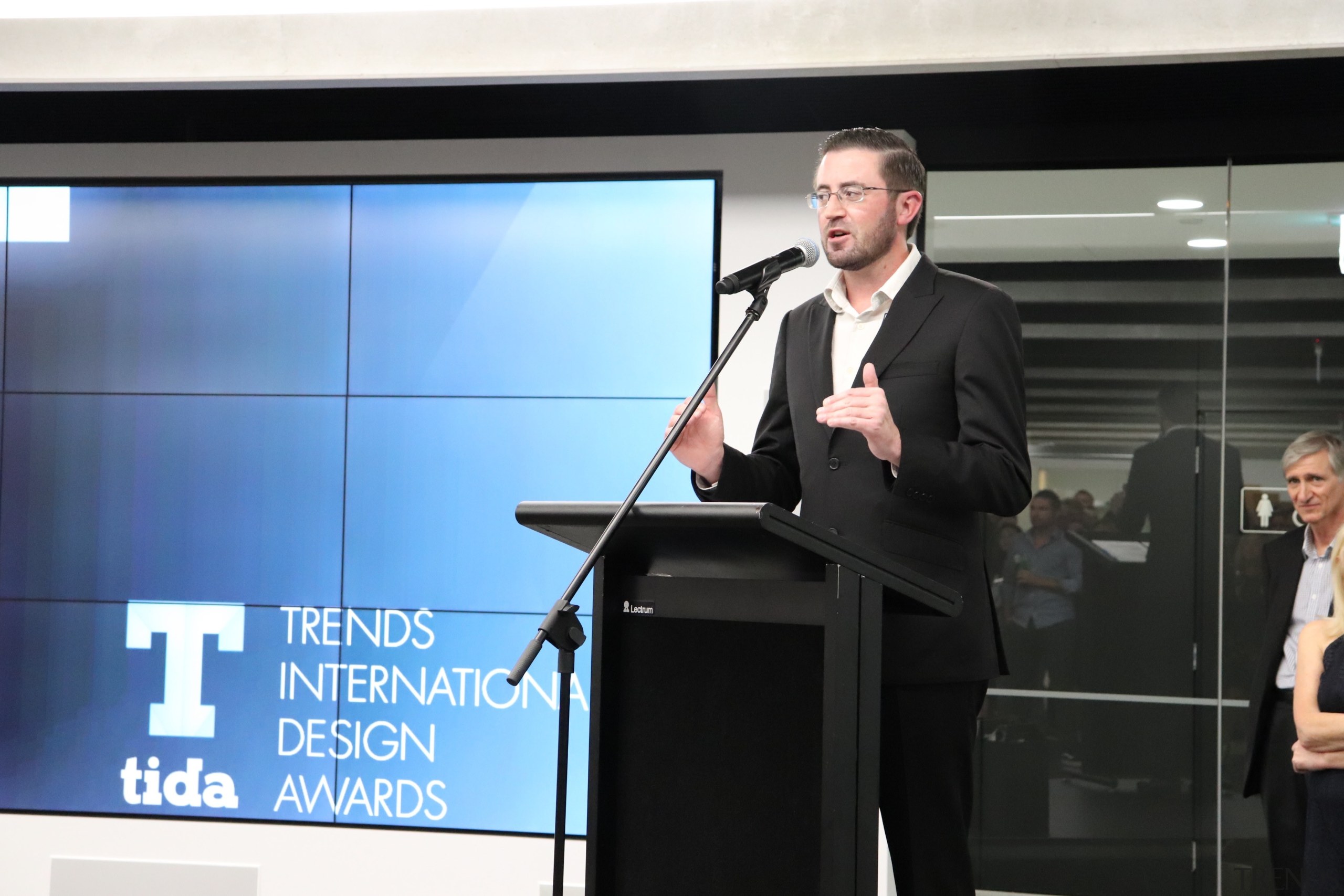 2018 Tida New Zealand Kitchens Awards Event 26 business, businessperson, communication, electronic device, orator, presentation, public relations, public speaking, speaker, speech, technology, black