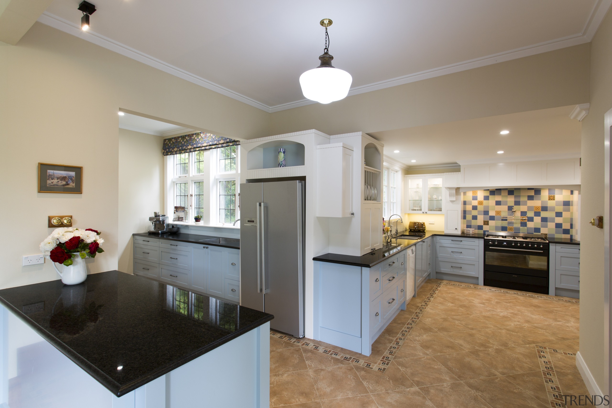 This multi-space kitchen was created by Mastercraft Kitchens. cabinetry, ceiling, countertop, cuisine classique, estate, home, interior design, kitchen, living room, property, real estate, room, gray