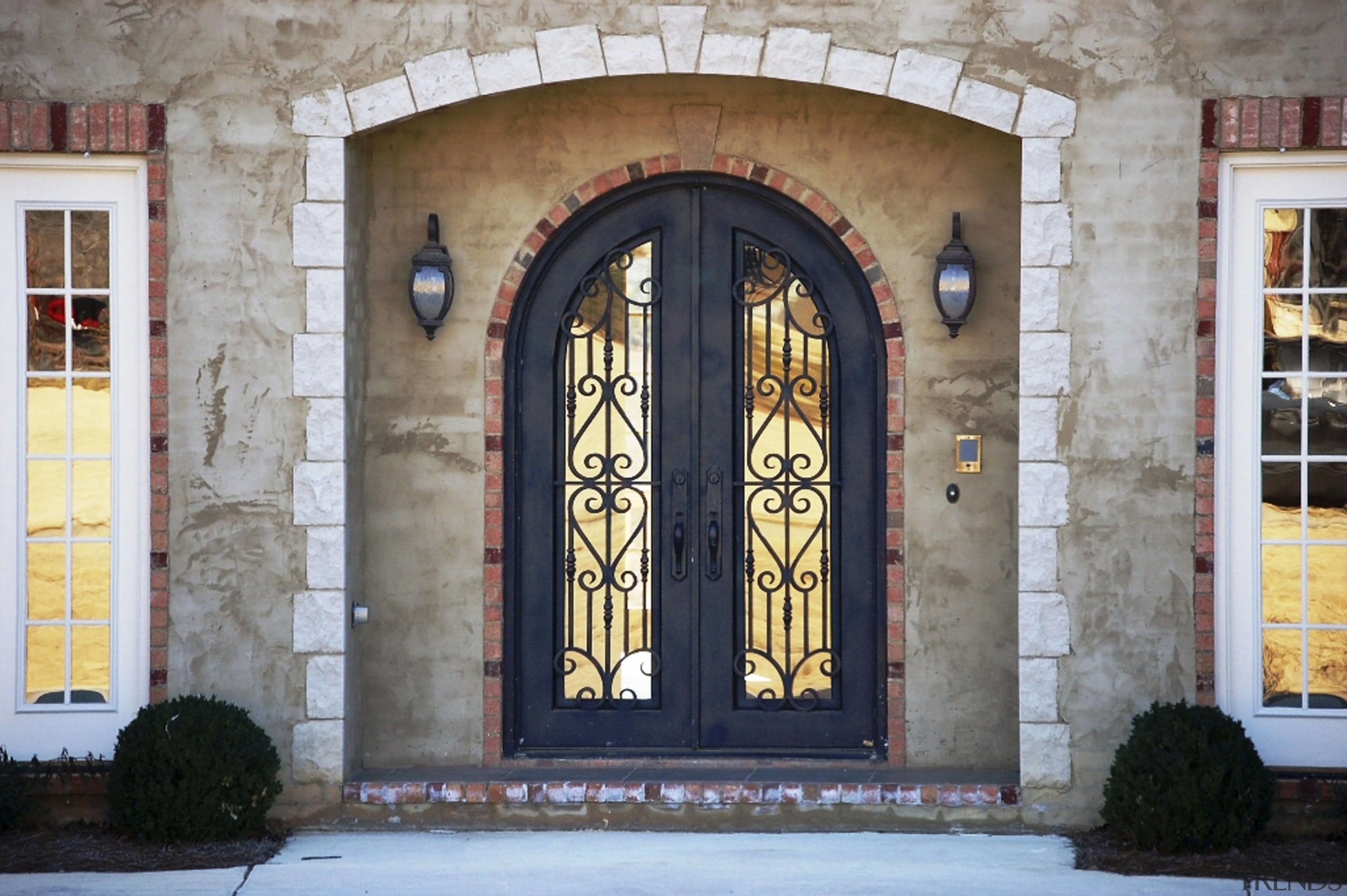 View of the entrance way which features Iron arch, door, facade, iron, structure, window, gray