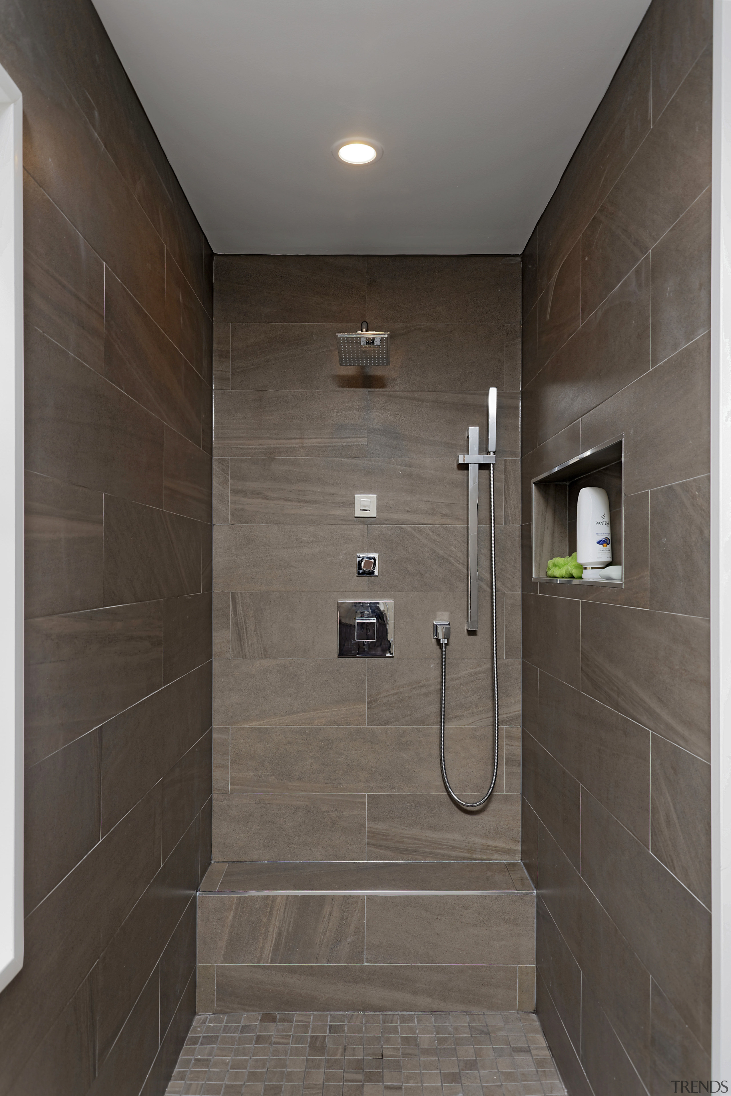 The two his and hers shower niches are bathroom, daylighting, floor, flooring, interior design, plumbing fixture, room, shower, tile, wall, gray, black