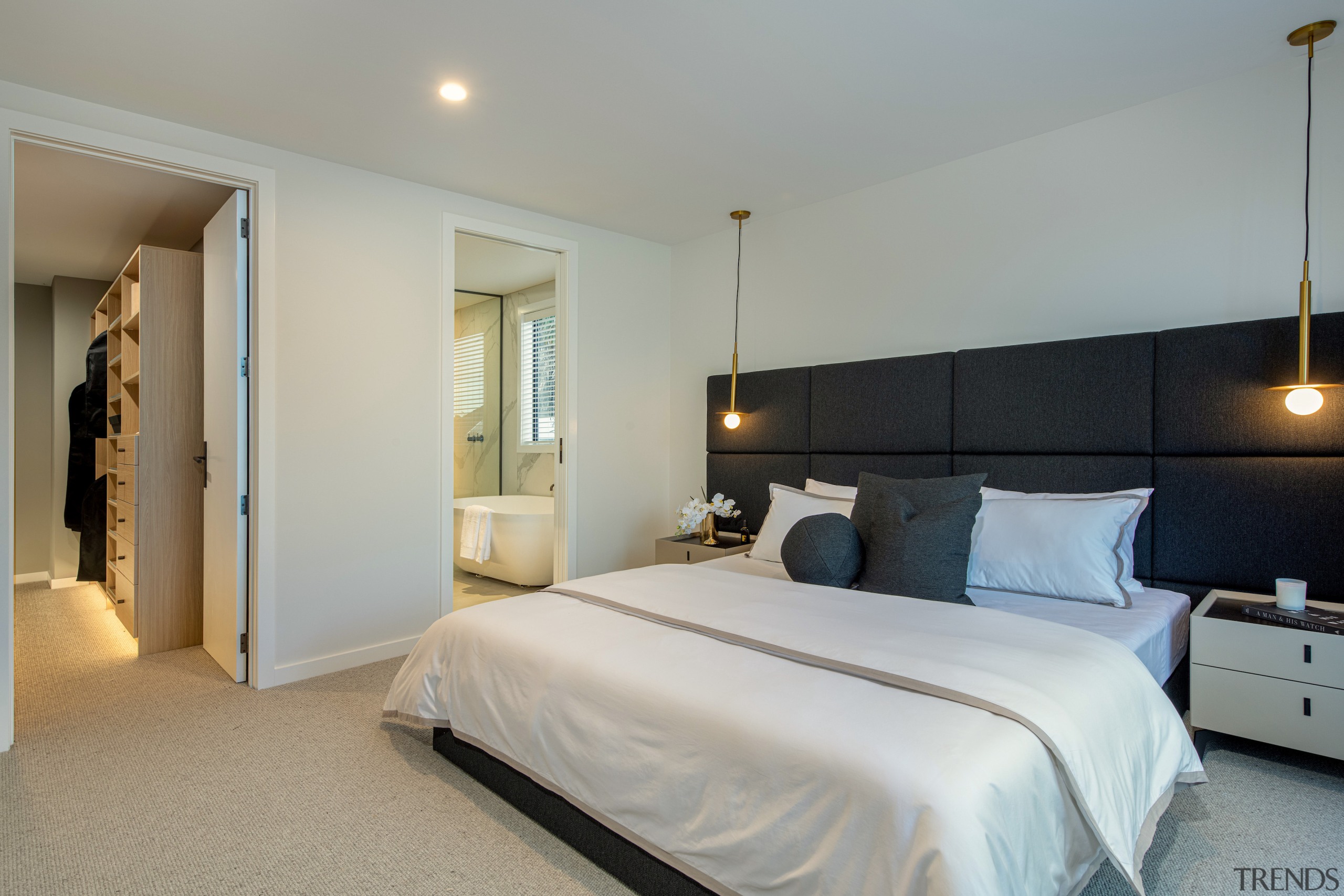 The spacious master suite bedroom with stand-out headboard 