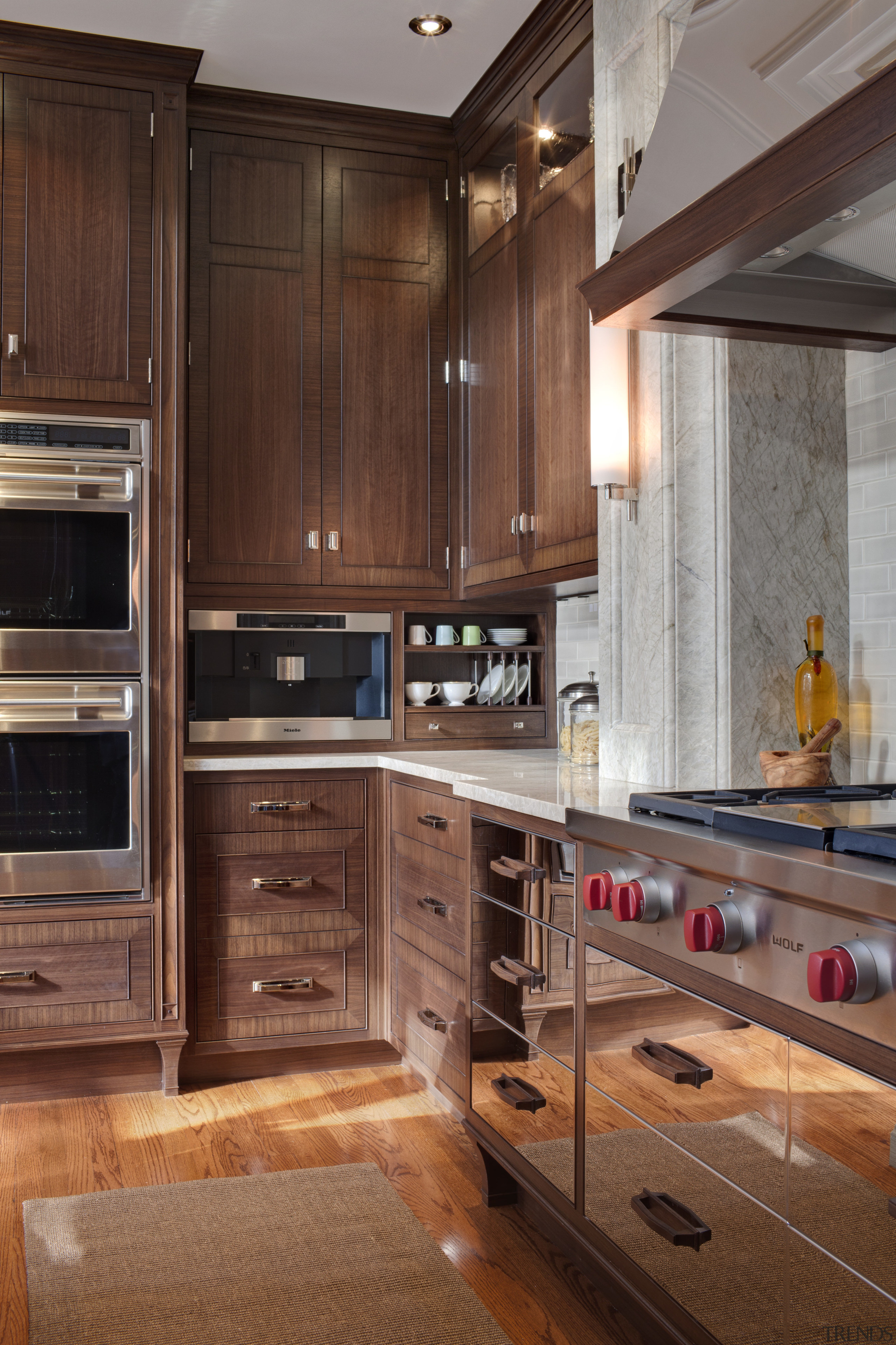 Stainless steel appliances.  Dark walnut surfaces. Custom cabinetry, countertop, cuisine classique, floor, flooring, hardwood, interior design, kitchen, room, under cabinet lighting, wood flooring, wood stain, brown