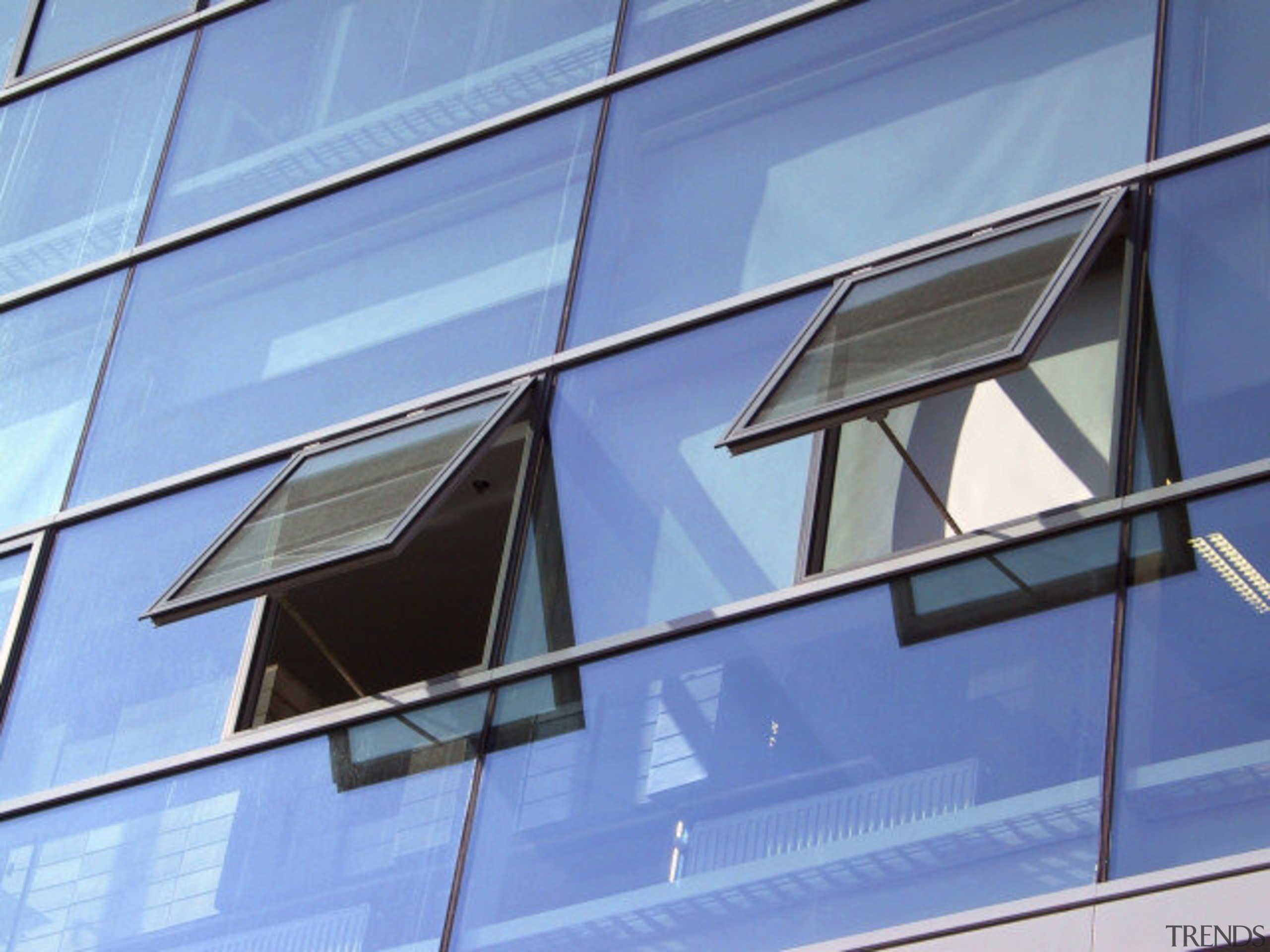 Close up of open windows. - Close up angle, architecture, blue, building, commercial building, corporate headquarters, daylighting, daytime, facade, glass, line, sky, structure, symmetry, window, teal