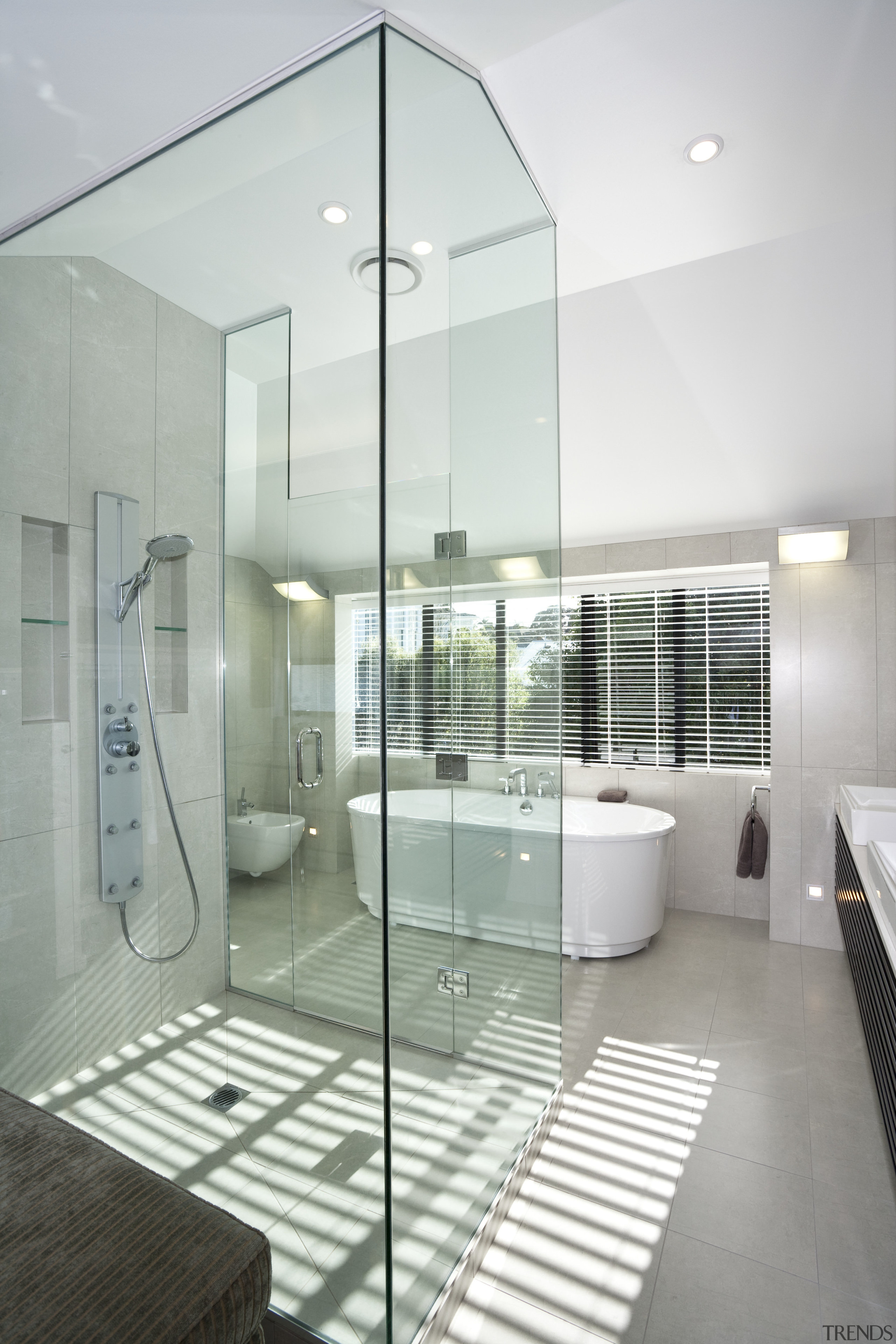 The glass shower enclosure separates the dressing room architecture, bathroom, condominium, daylighting, floor, glass, interior design, real estate, gray, white