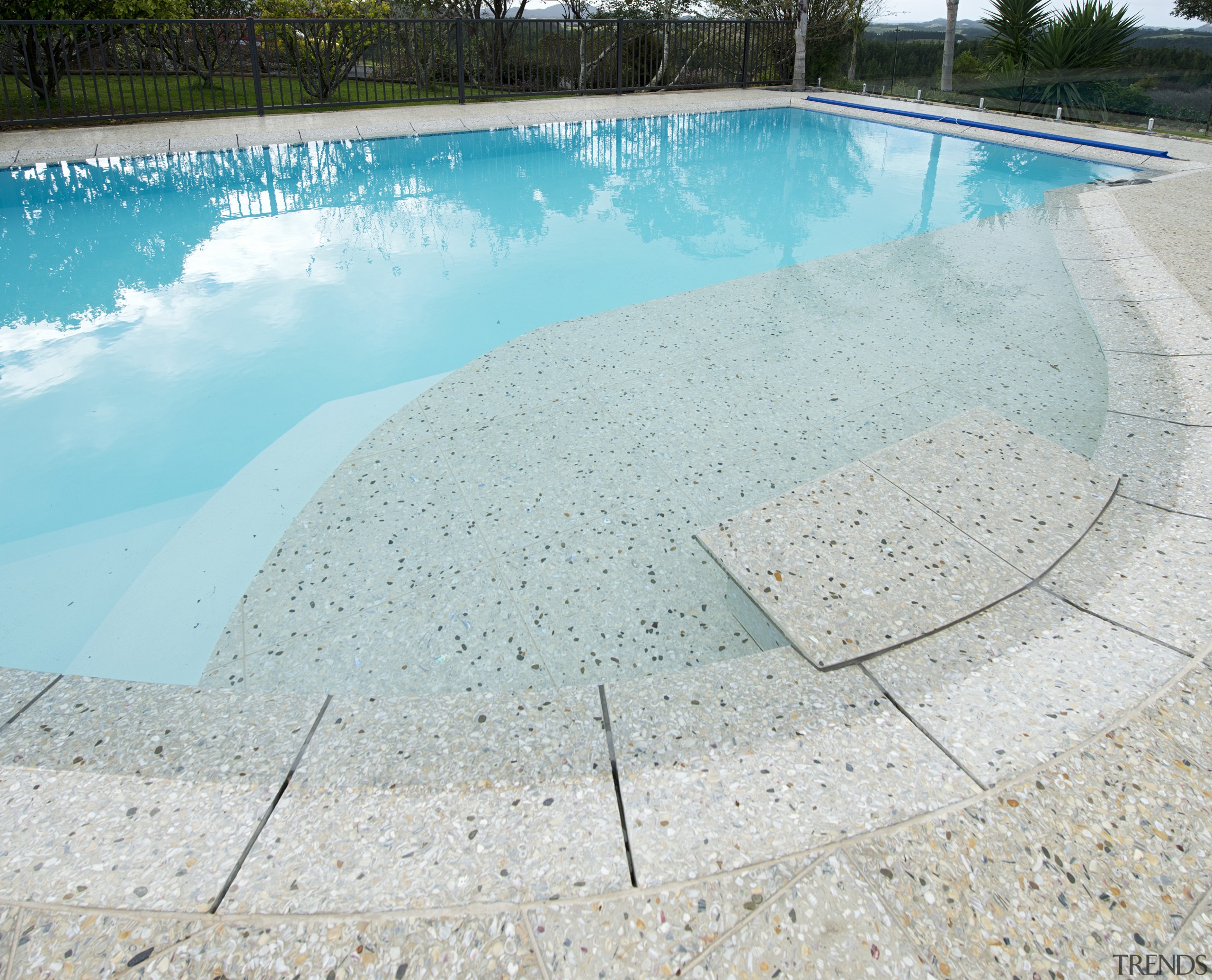 This inground pool features a shallow beach with aqua, leisure, swimming pool, water, water resources, gray