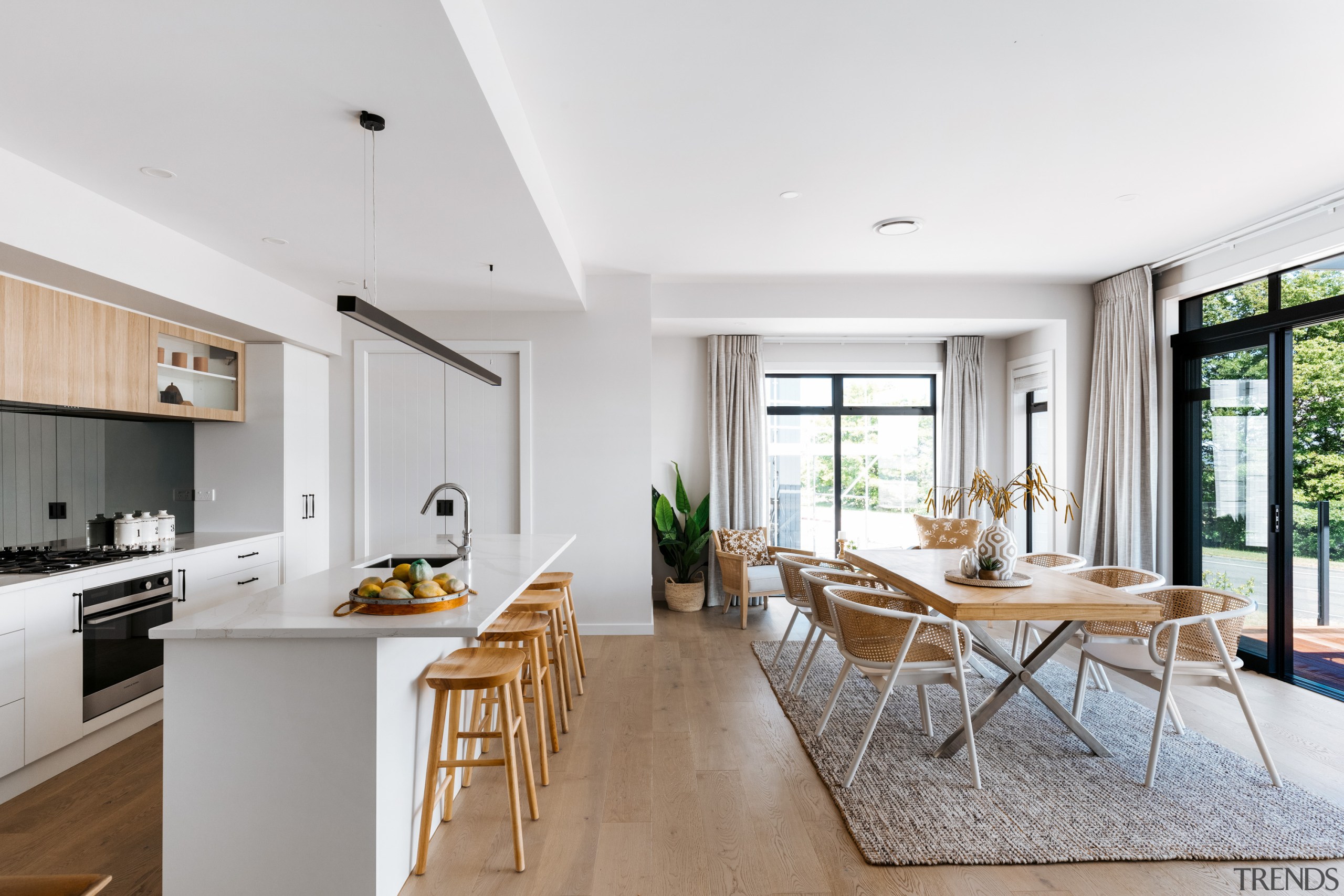 The well-appointed kitchen features a stone-top island bench, 