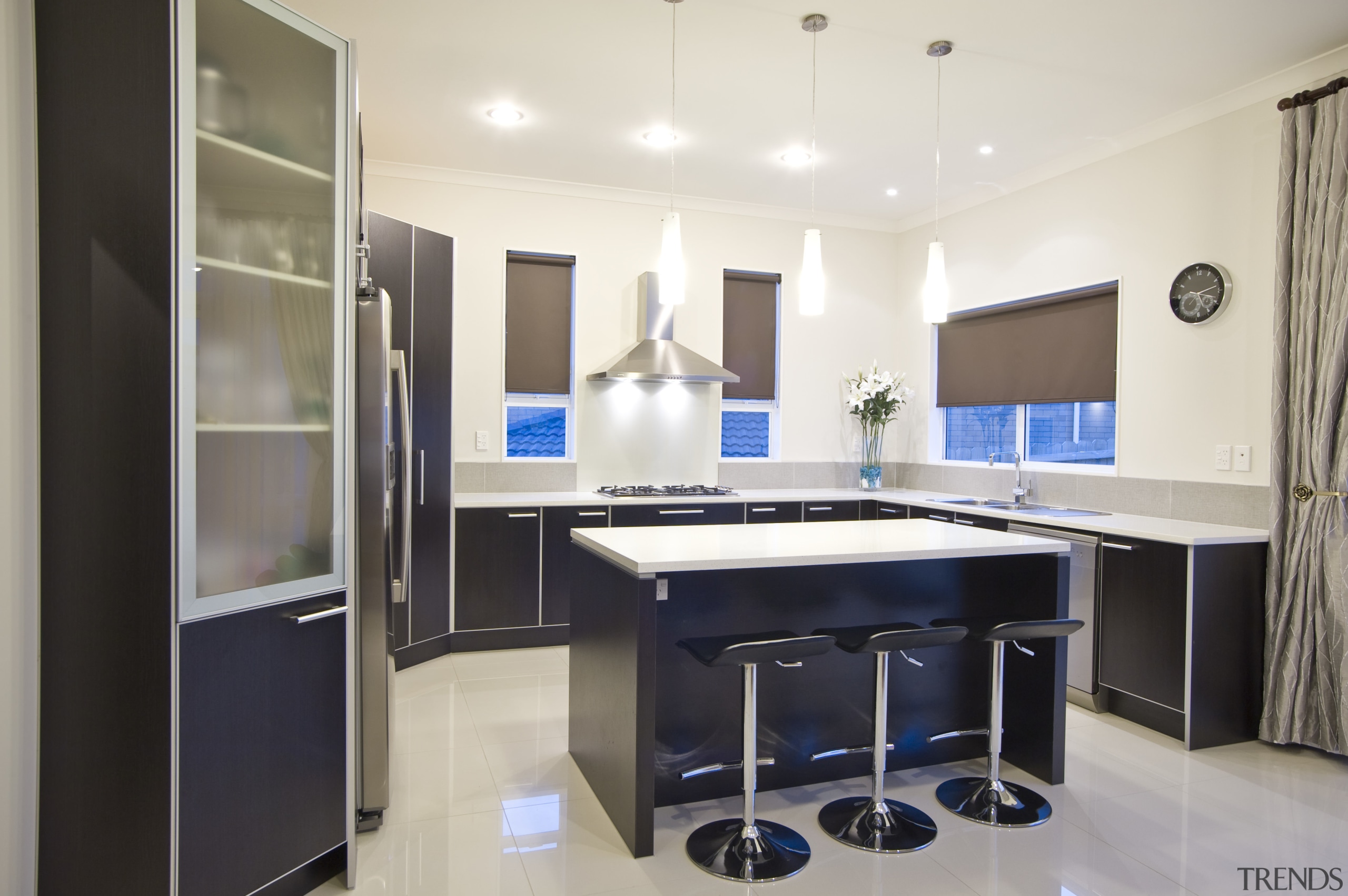 View of a kitchen which features dark stained cabinetry, countertop, interior design, kitchen, real estate, room, white