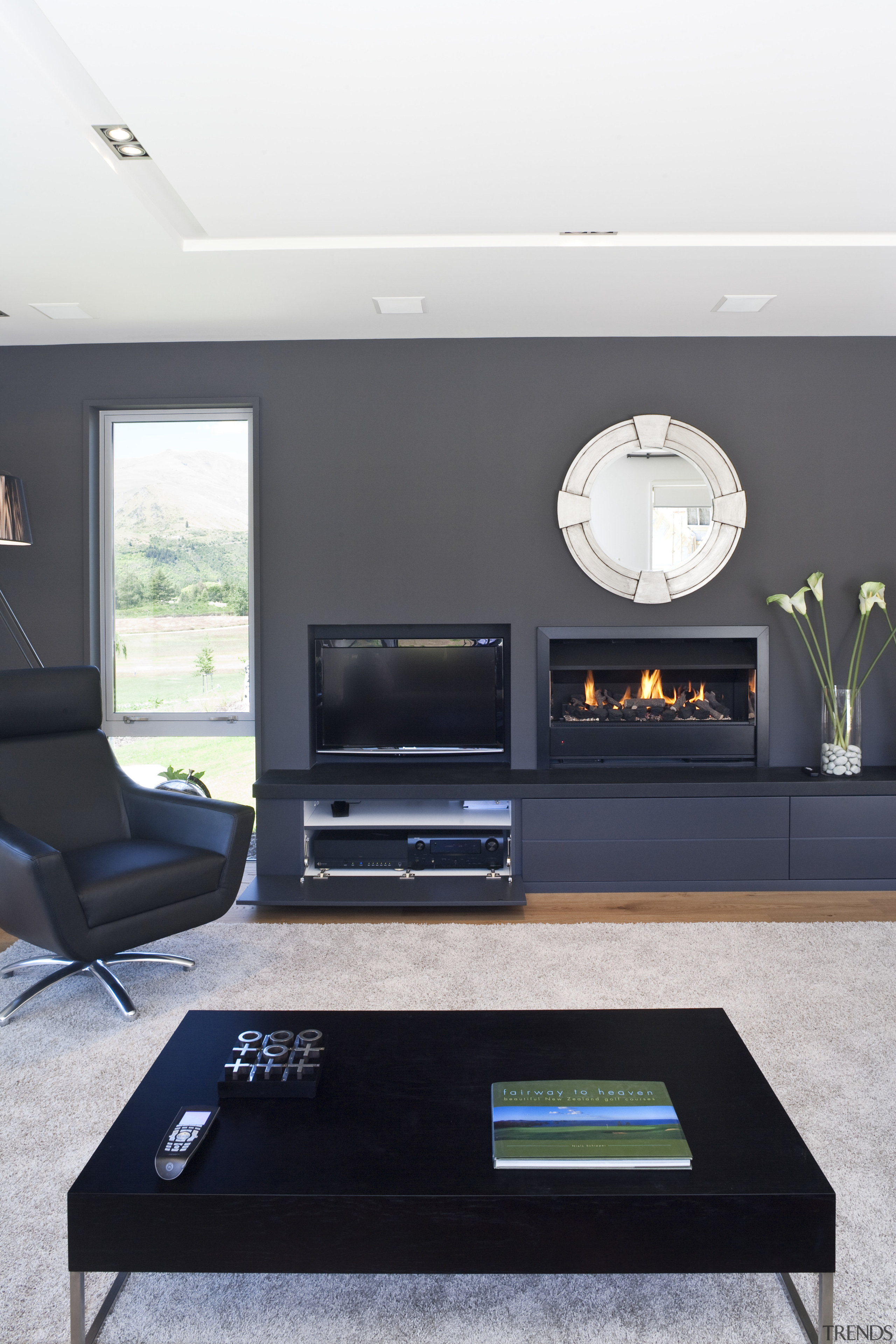 View of the lounge which features oak flooring, furniture, interior design, living room, table, white, black