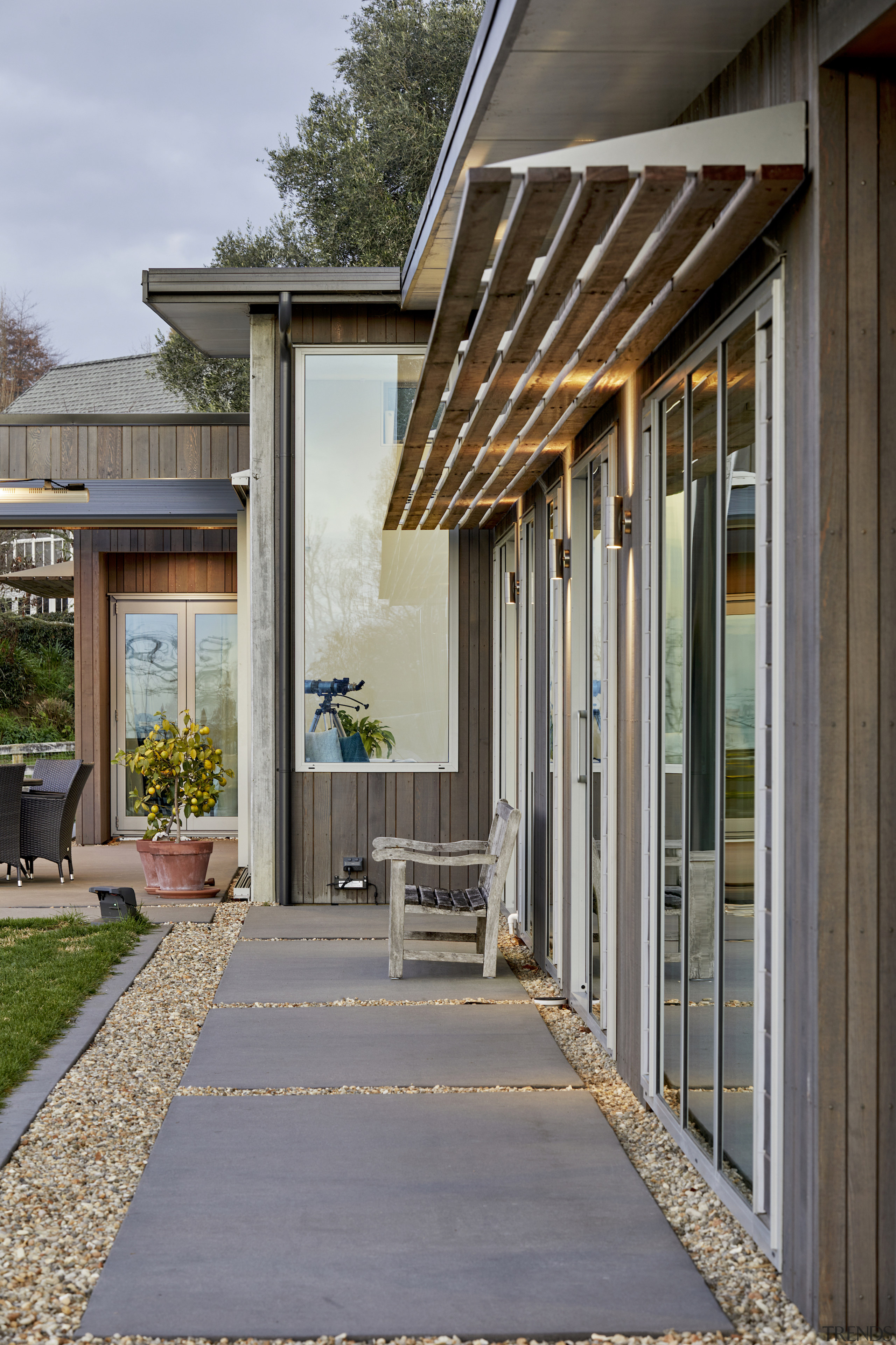 Slatted timber and steel sunshades protect from solar 