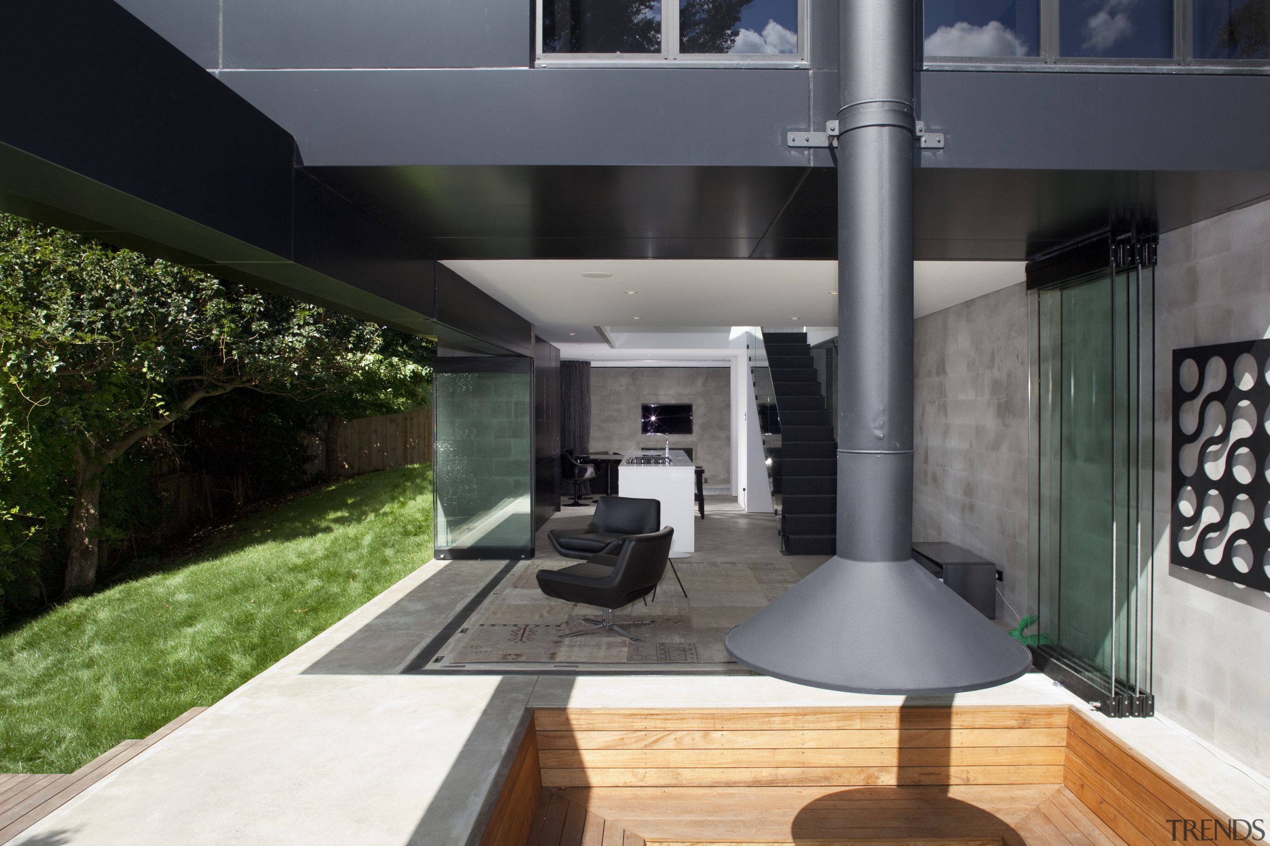 Black exterior, chimney, outside house looking at patio architecture, house, interior design, real estate, black, gray