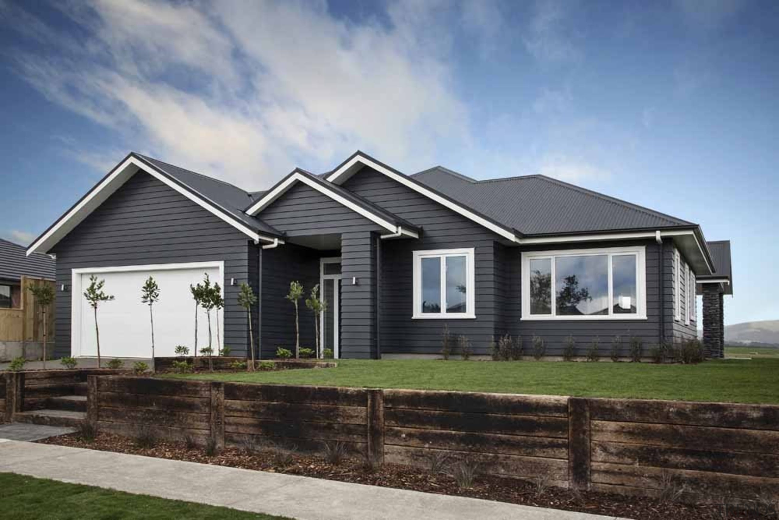 This timeless design has a gracious entry to building, cottage, elevation, estate, facade, farmhouse, home, house, landscape, property, real estate, residential area, siding, sky, gray, black