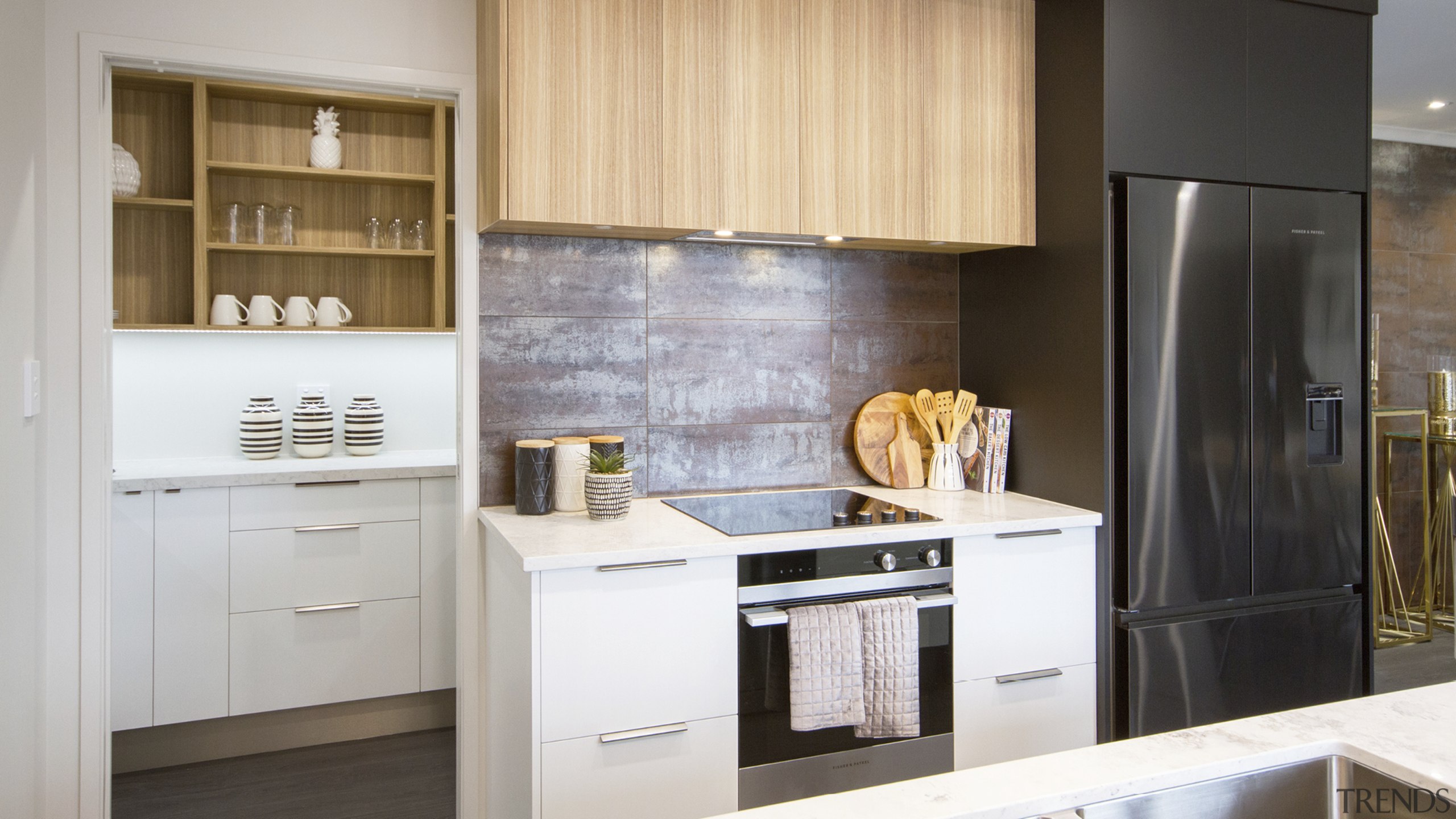 The kitchen's attractive grained wood and white cabinetry 