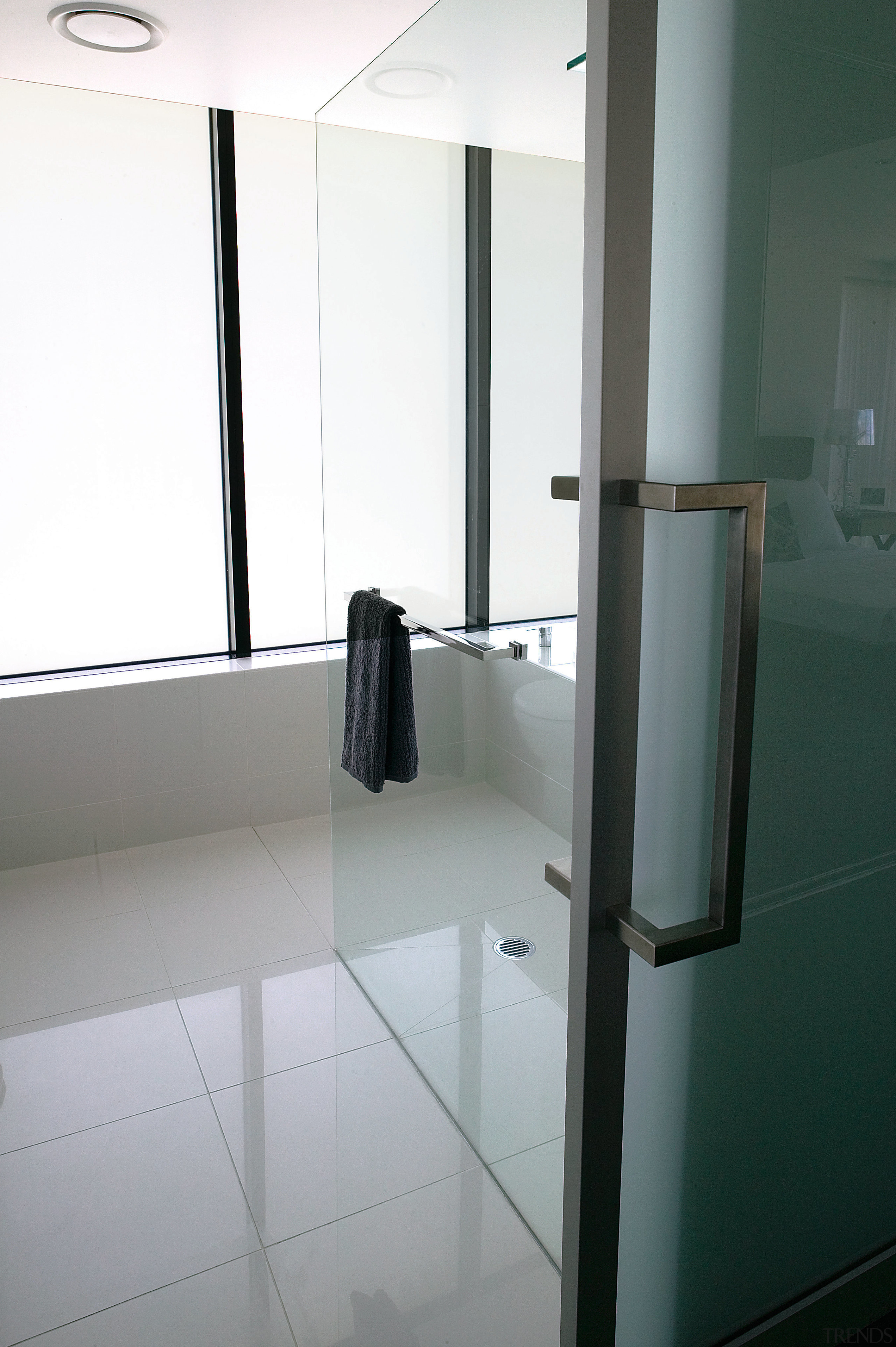 A view of the bathroom featuring  frameless architecture, bathroom, daylighting, floor, flooring, glass, interior design, product design, property, tile, window, gray, white