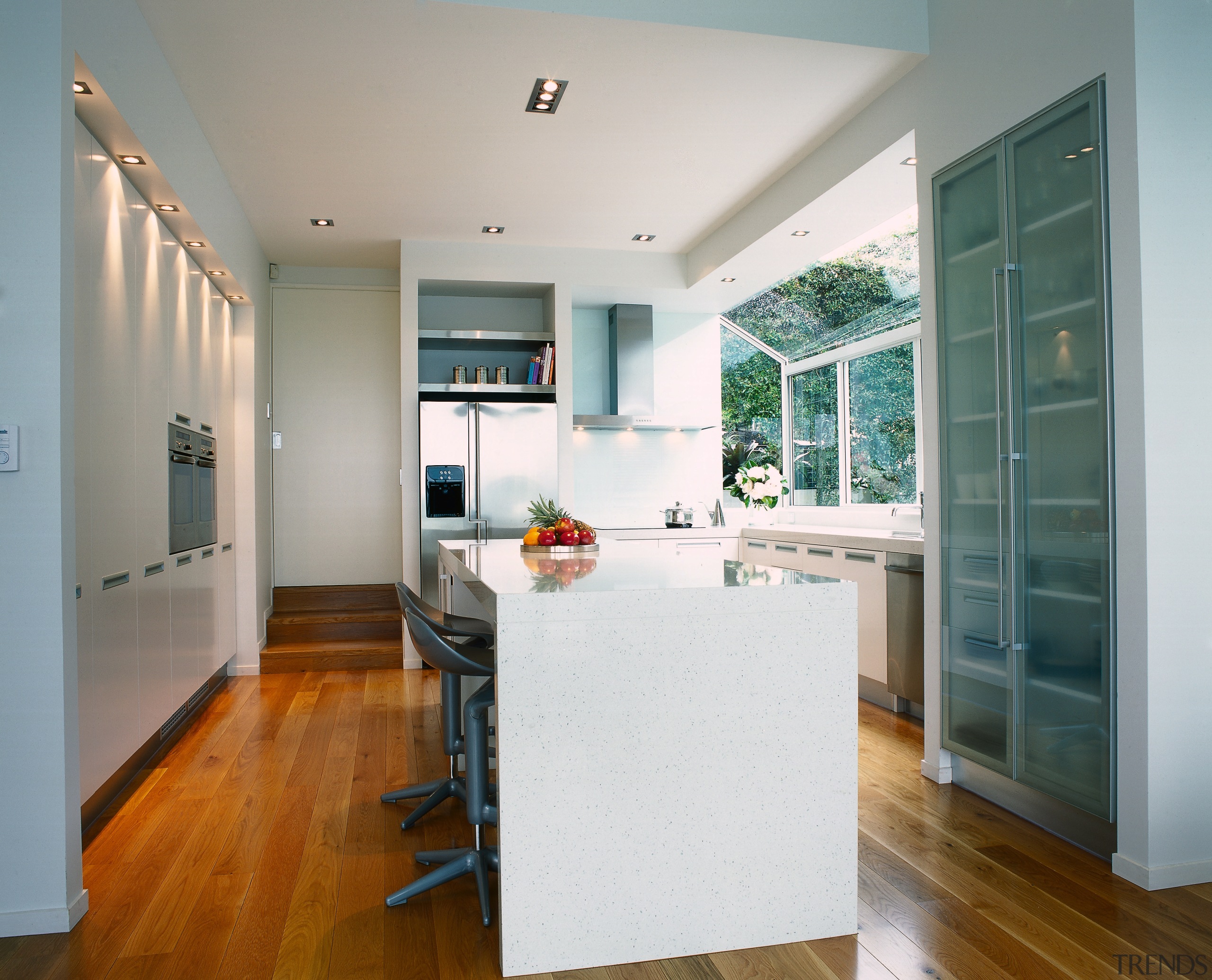 Kitchen with light coloured cabinetry and benchtops, timber architecture, cabinetry, countertop, floor, flooring, hardwood, home, house, interior design, kitchen, living room, real estate, room, window, wood flooring, gray